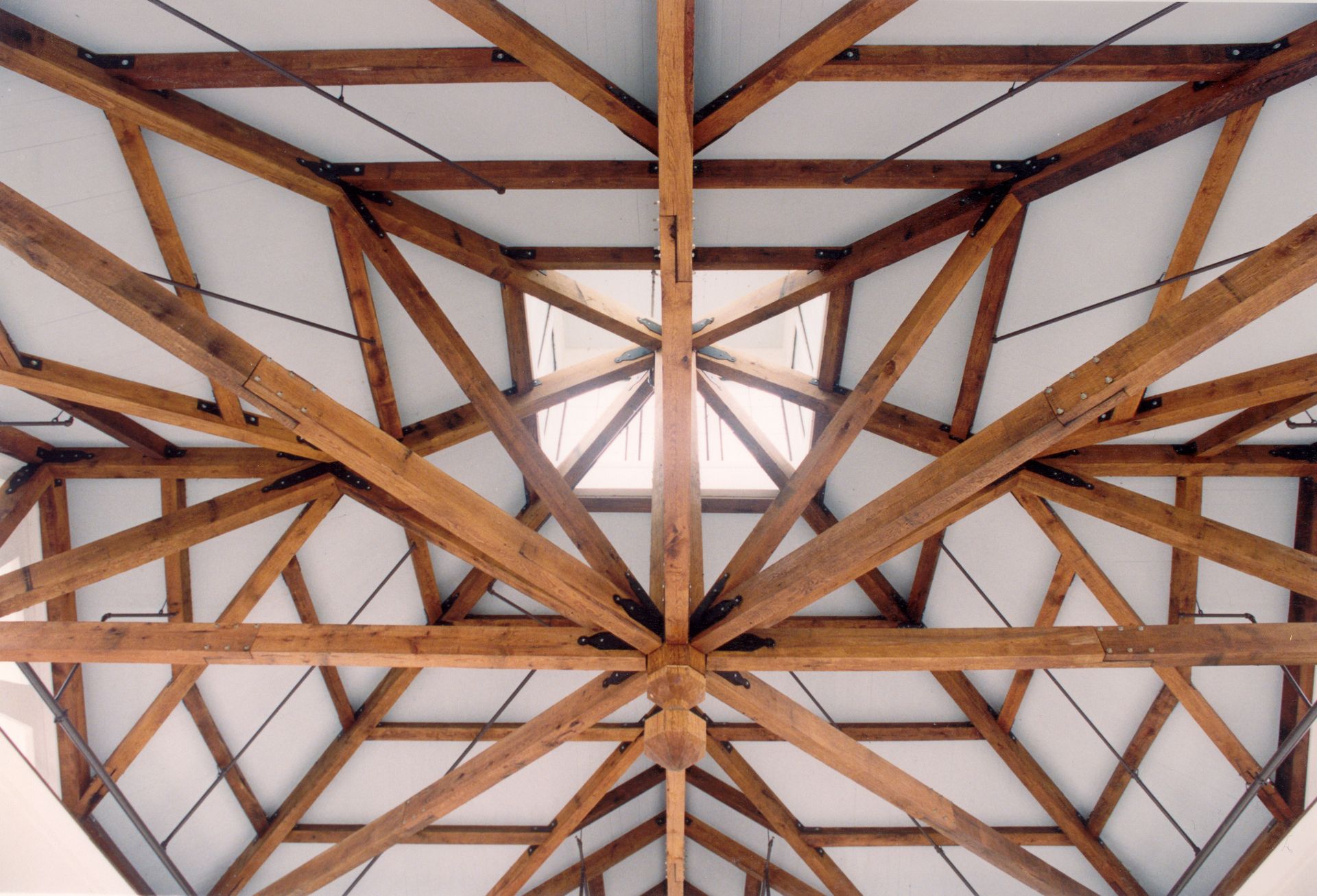 Looking up at the ceiling of a building with wooden beams