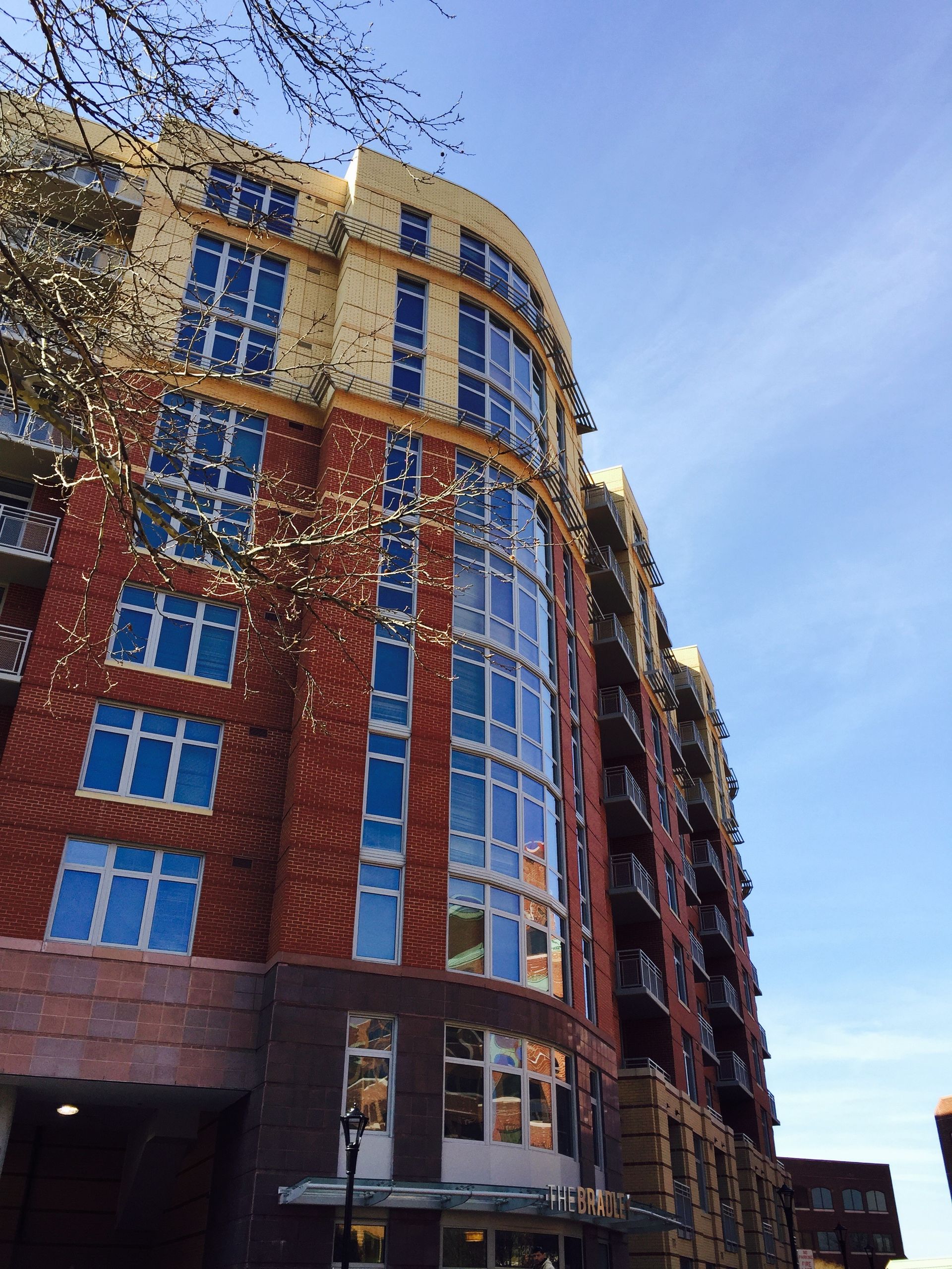 Looking up at a tall building with lots of windows
