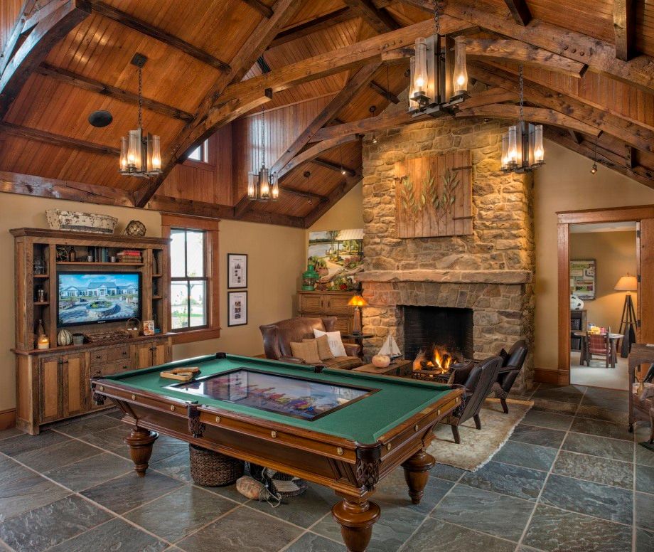 A living room with a pool table and a fireplace