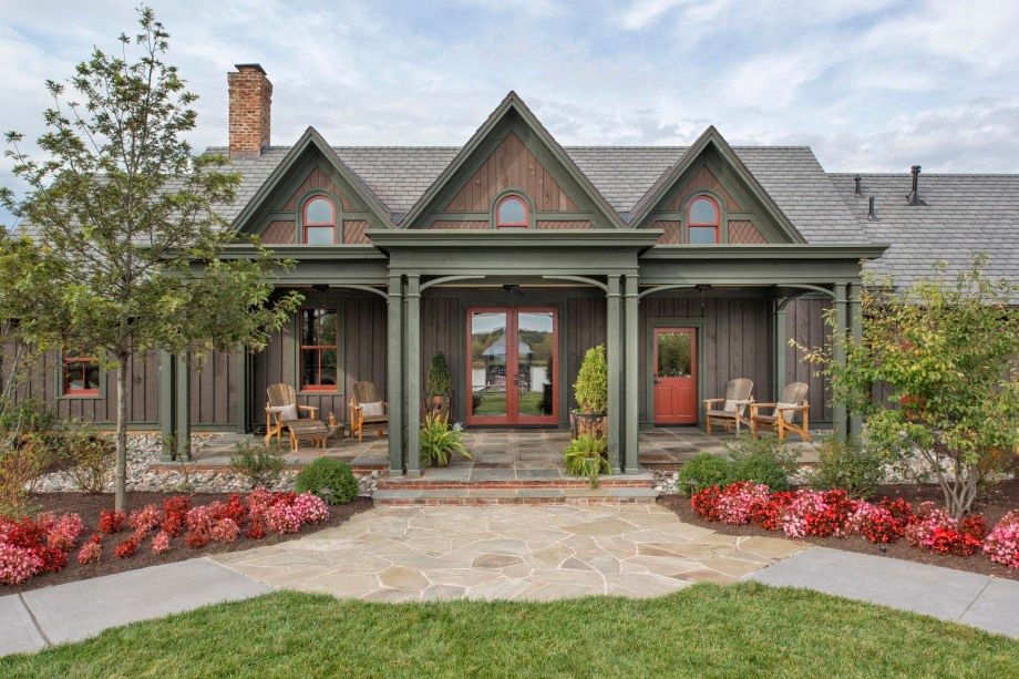 A large house with a large porch and a walkway leading to it.