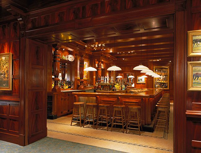 A restaurant with a long bar and stools