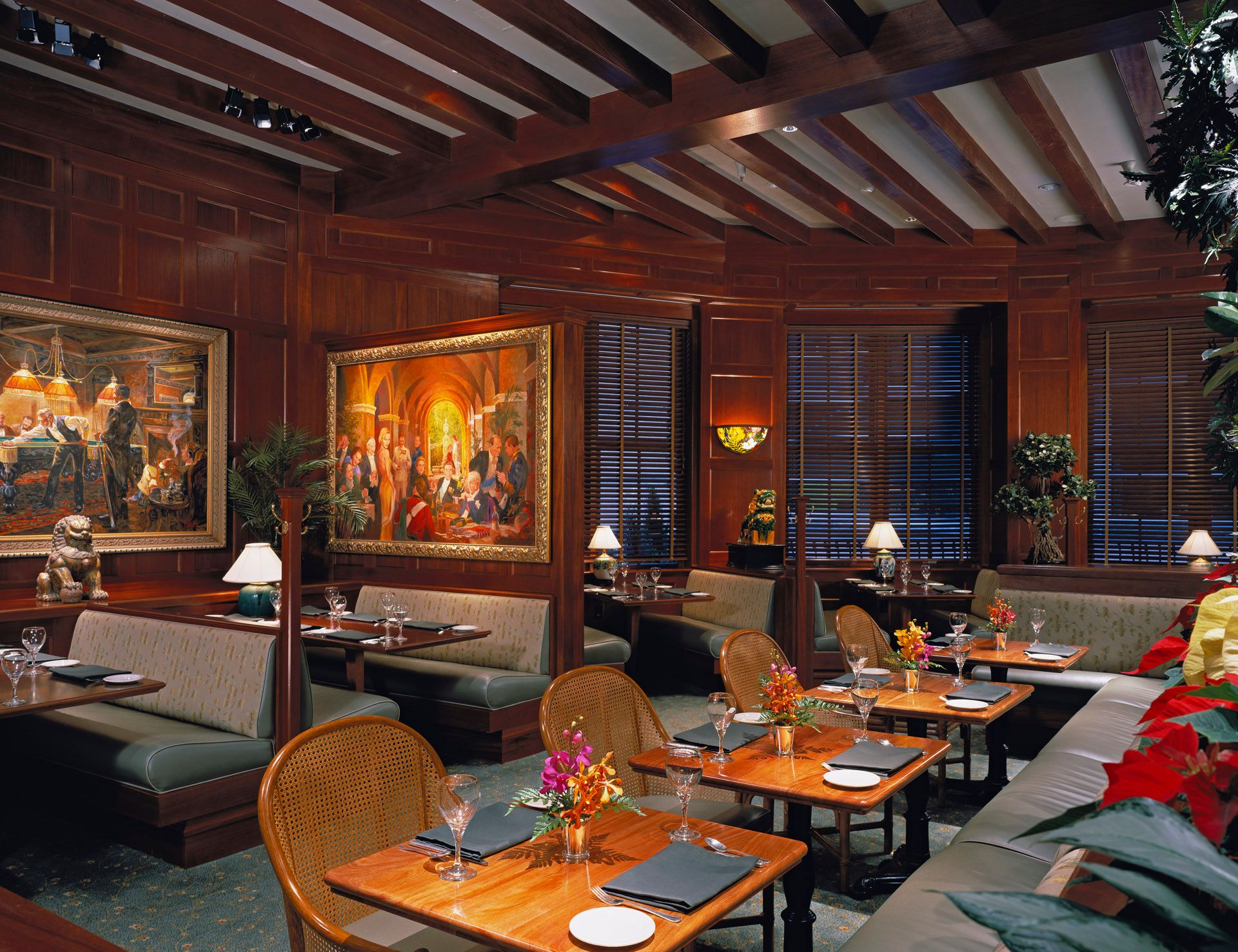 A restaurant with tables and chairs and a painting on the wall