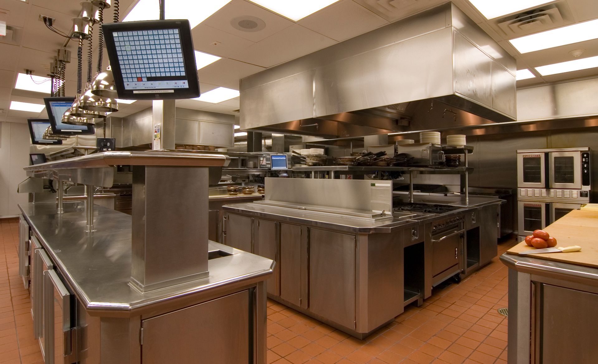 A large kitchen with lots of stainless steel appliances