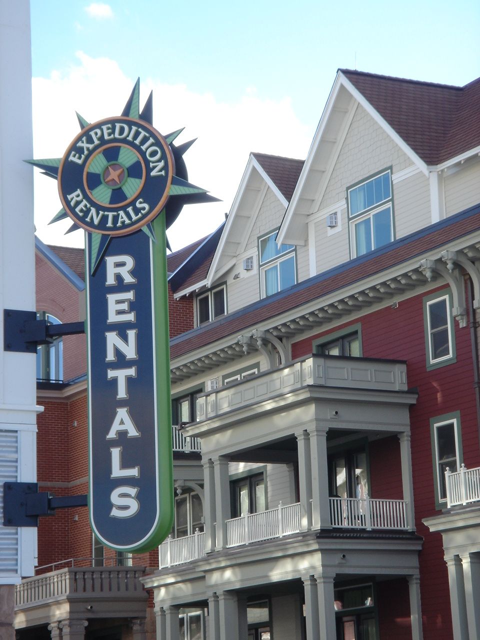 A sign for expedition rentals hangs in front of a building