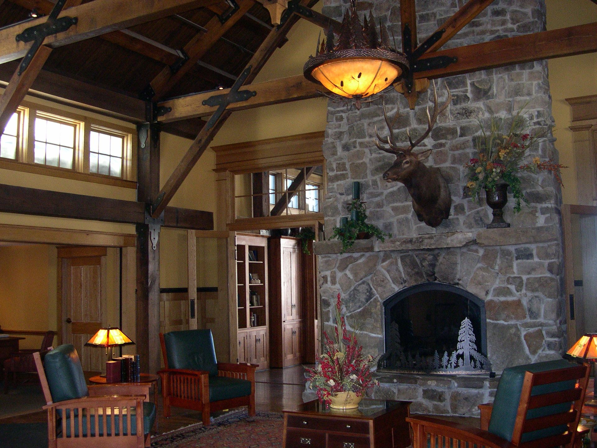 A large stone fireplace with a deer head on it