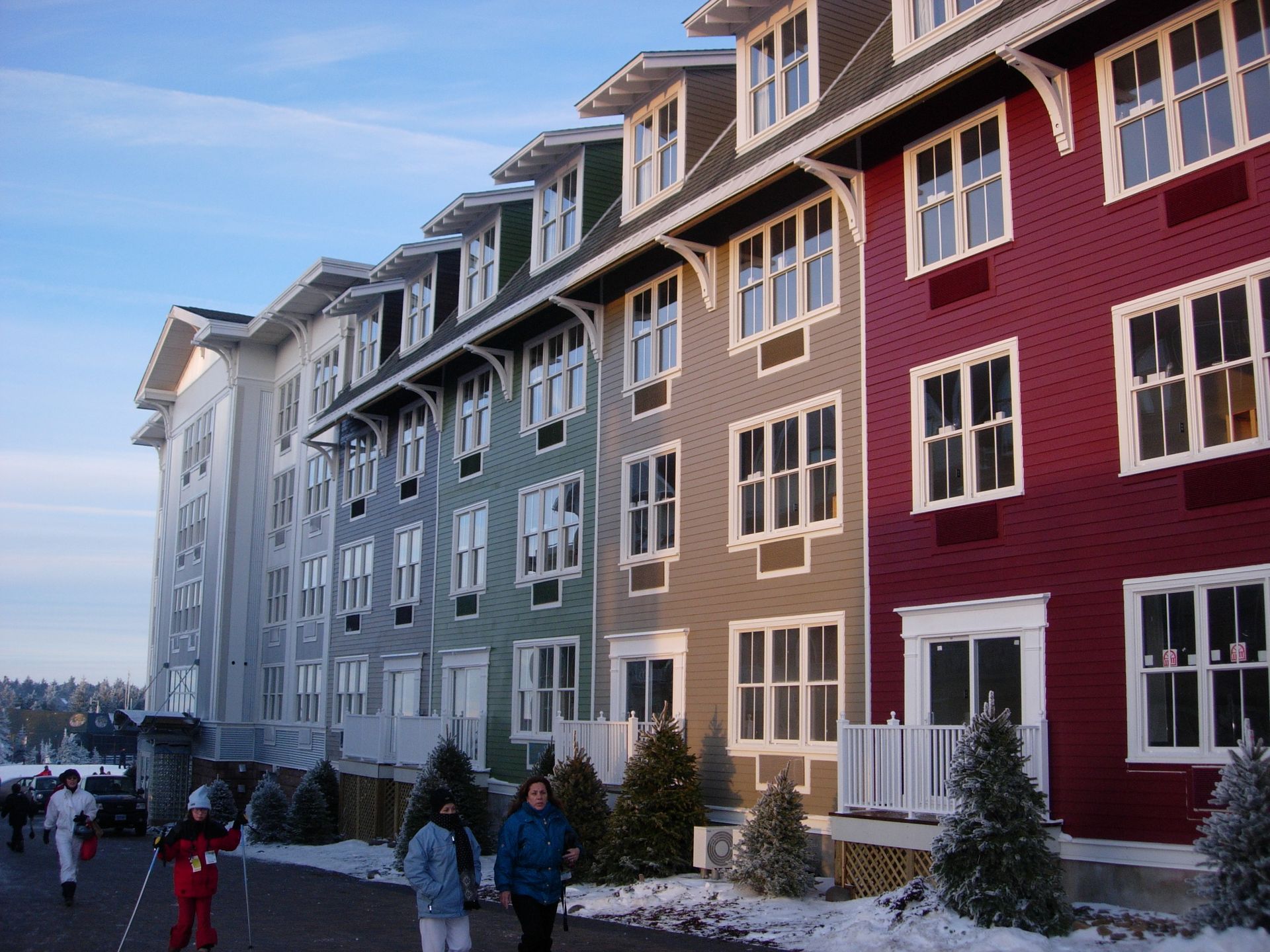 A row of buildings with a red building in the middle