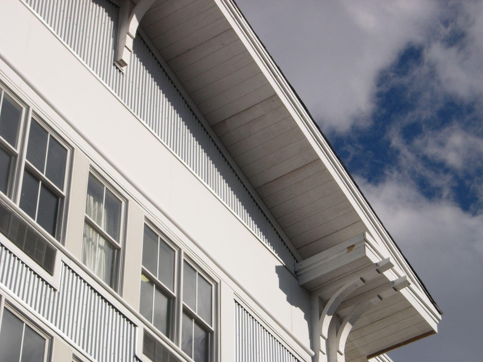 A white building with a blue sky in the background