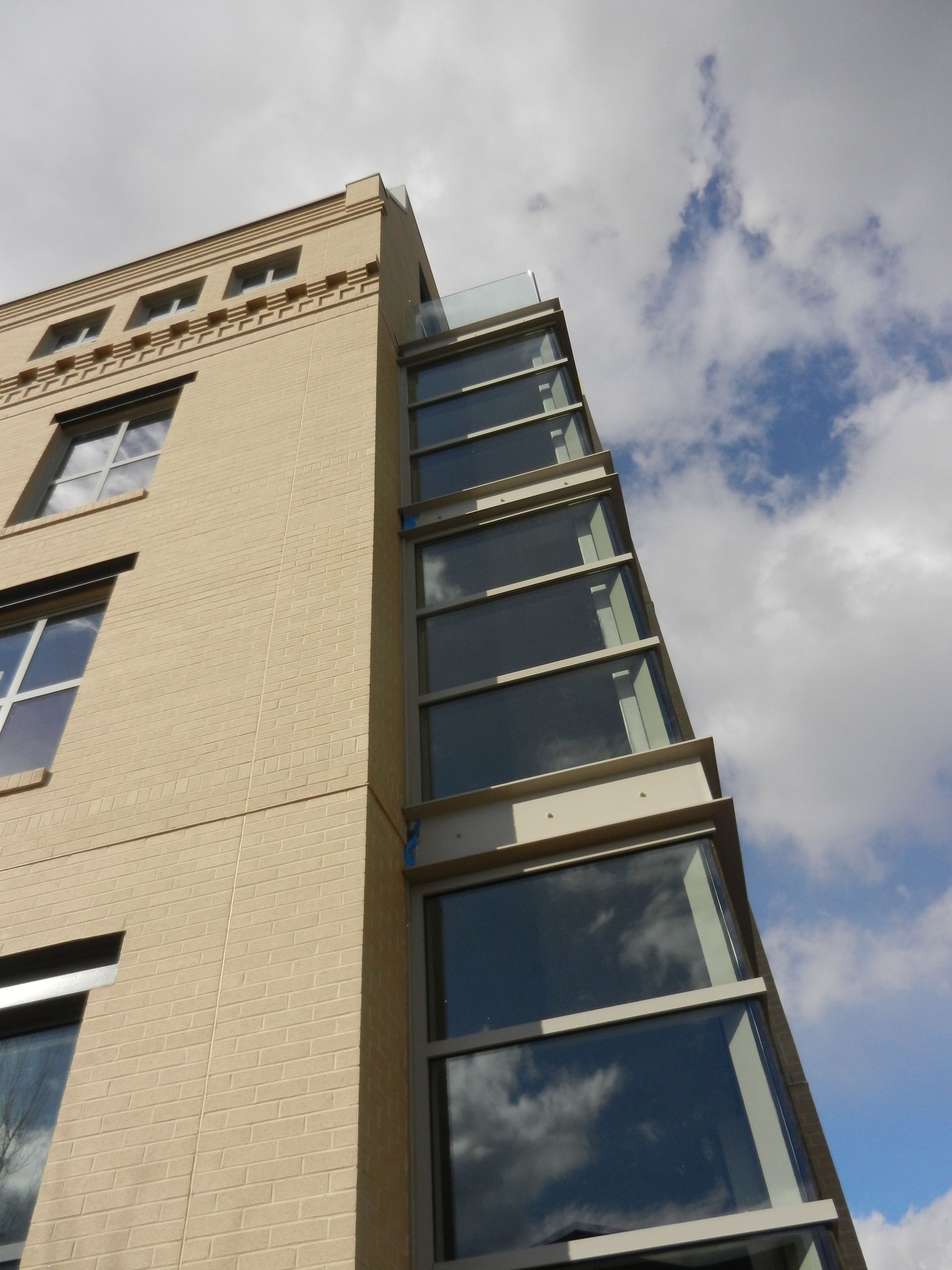 Looking up at a tall building with lots of windows