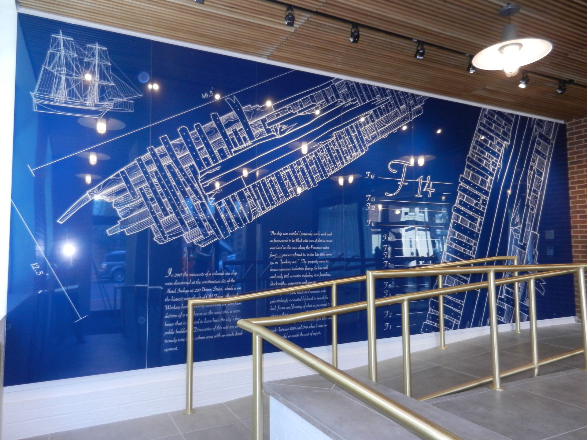 A blue wall with a drawing of a ship on it