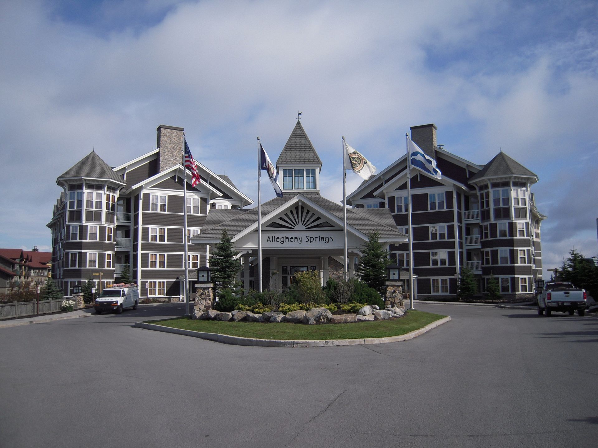 A large building with a few flags on it