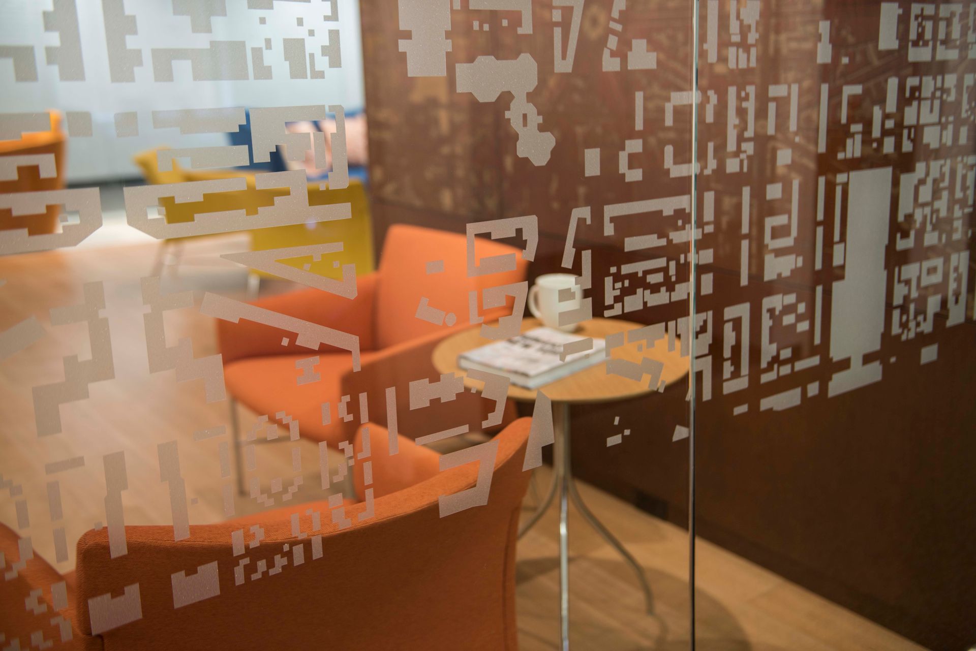 A room with orange chairs and a small table