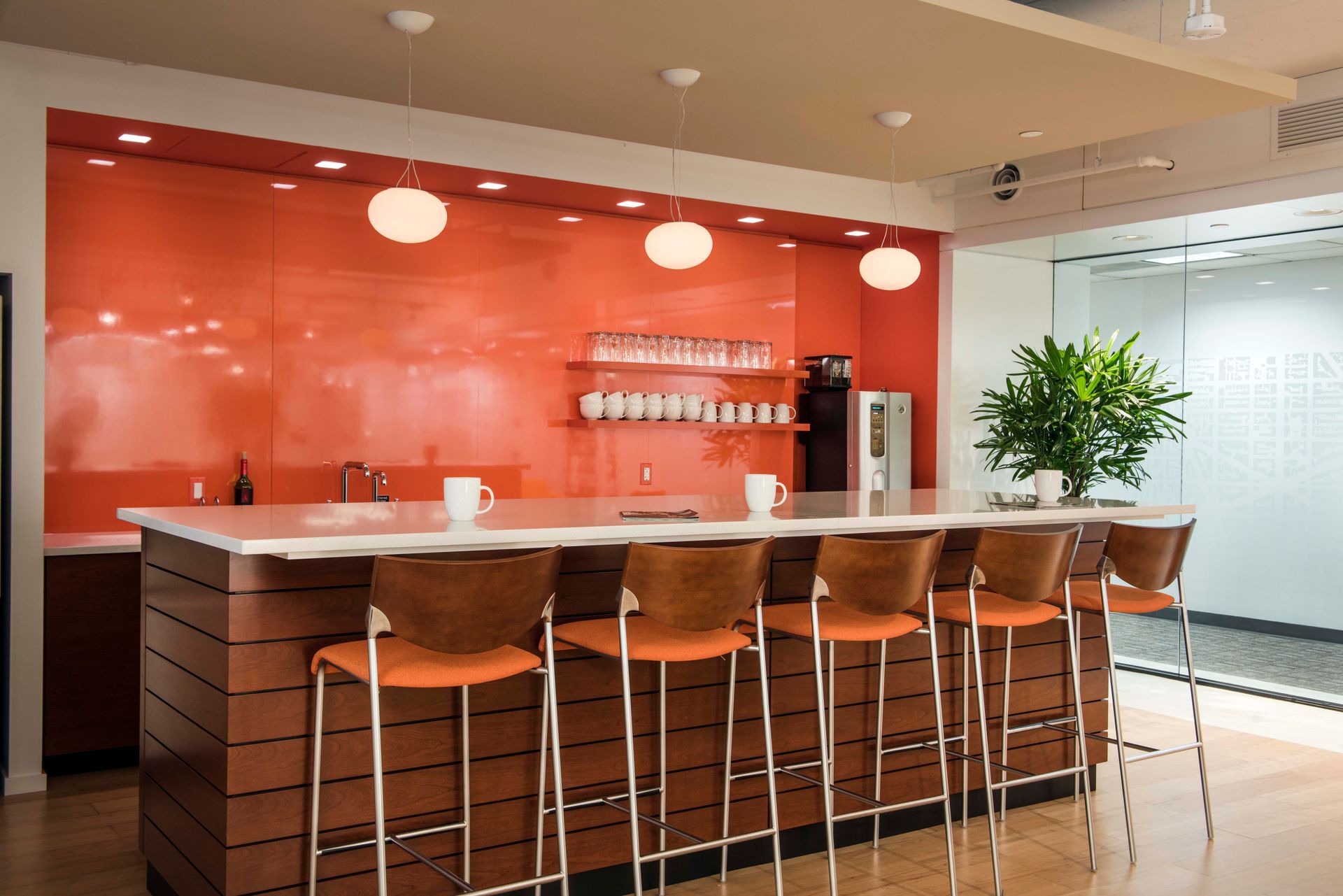 A kitchen with a long counter and stools