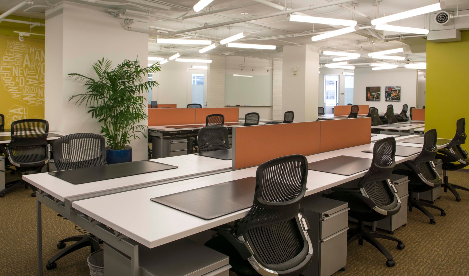 A large office with a lot of desks and chairs.