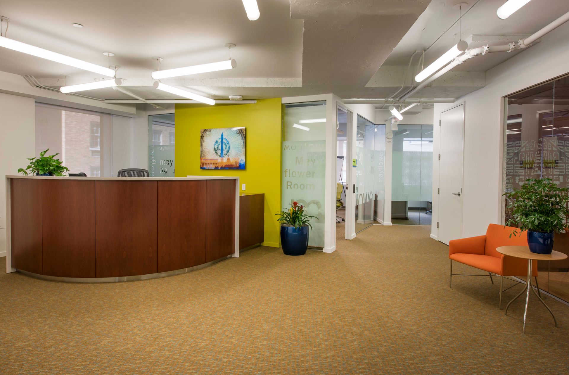 A reception area in an office with a dollar sign on the wall