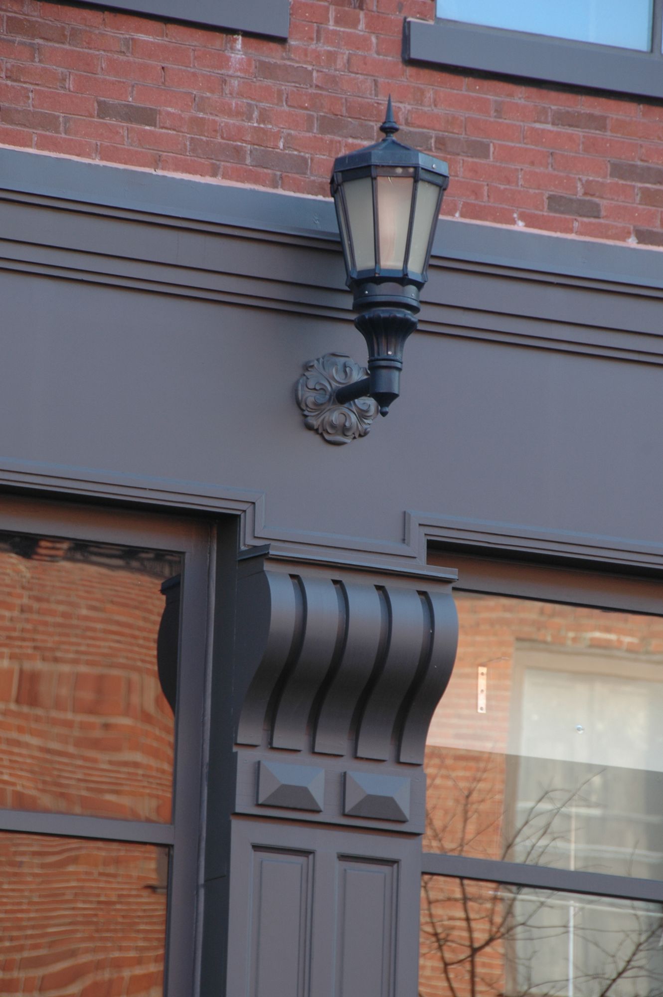 A lamp is mounted on the side of a building