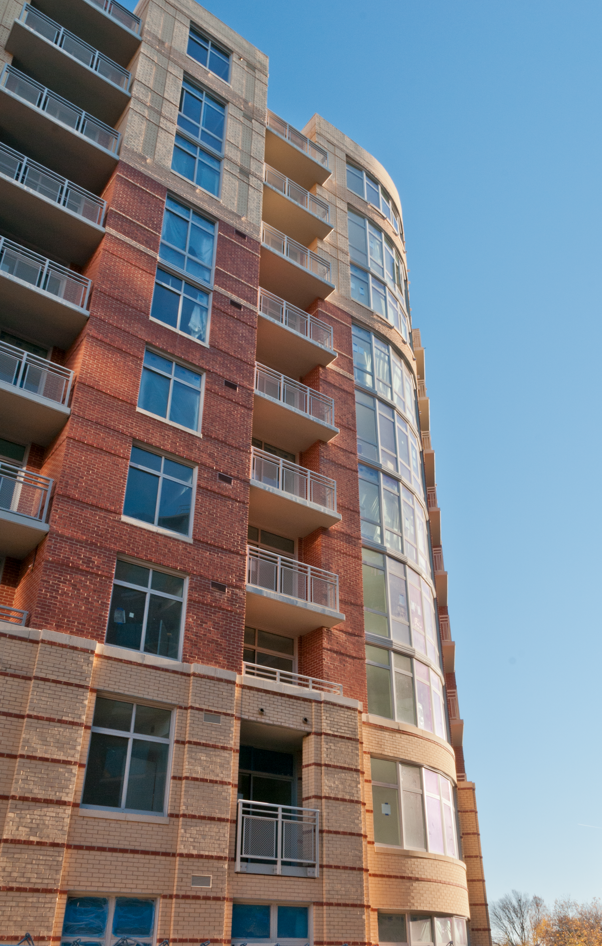 A tall building with a lot of windows and balconies