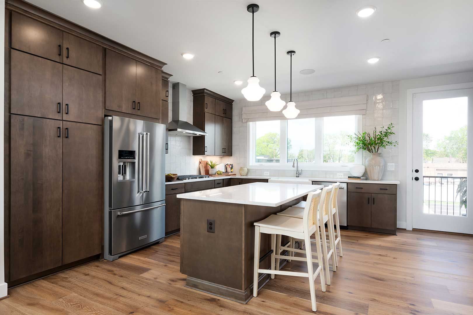 A kitchen with stainless steel appliances , wooden cabinets , and a large island.
