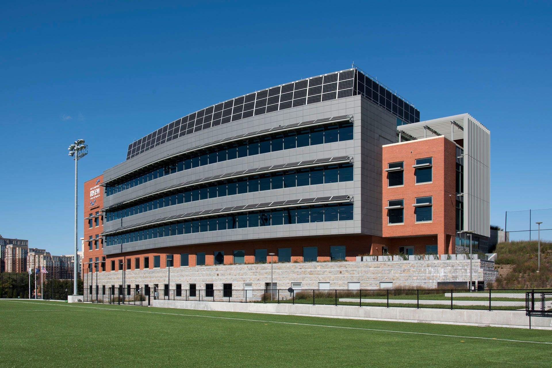 A large building with a stadium in front of it
