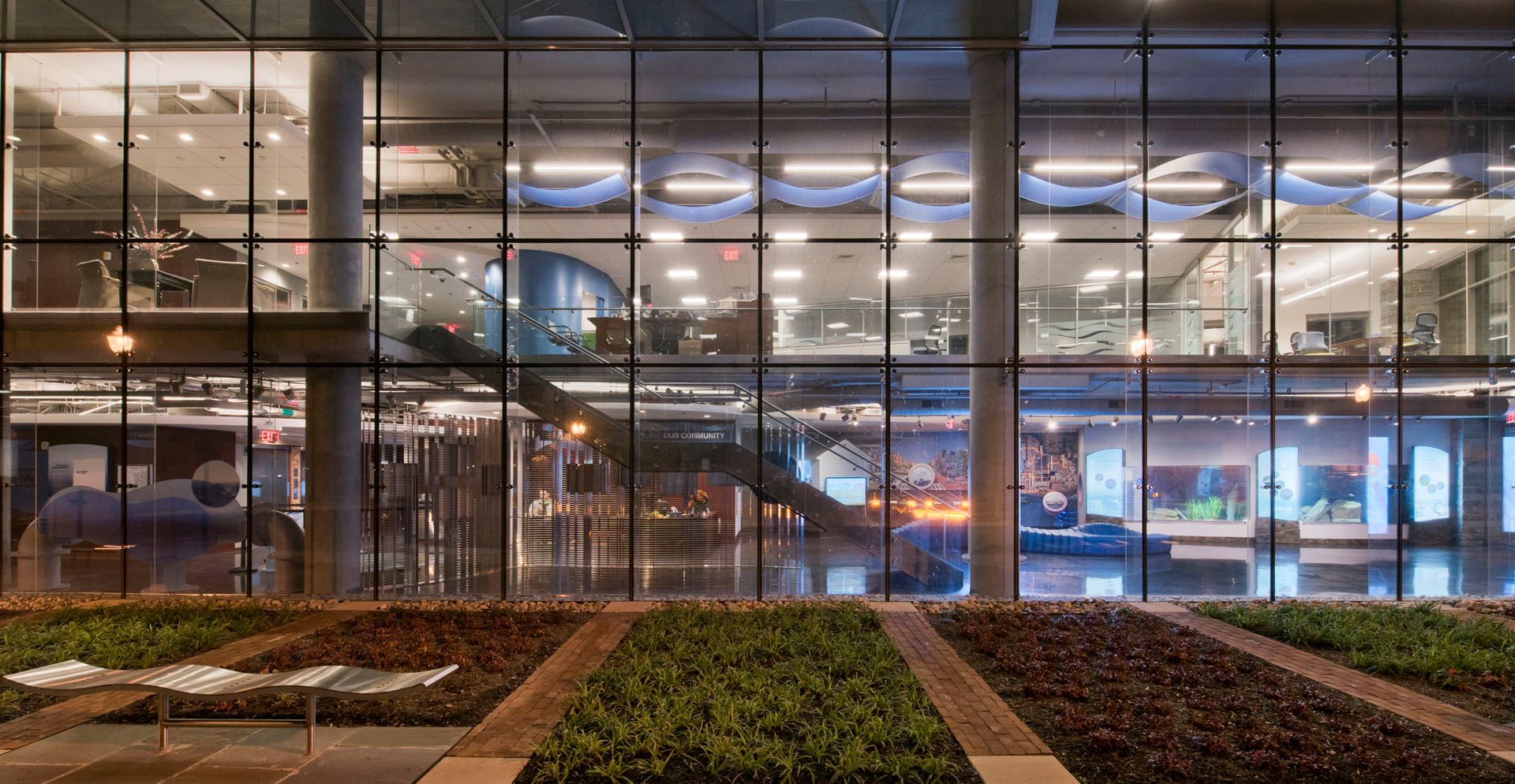 A large building with a lot of windows and a garden in front of it.