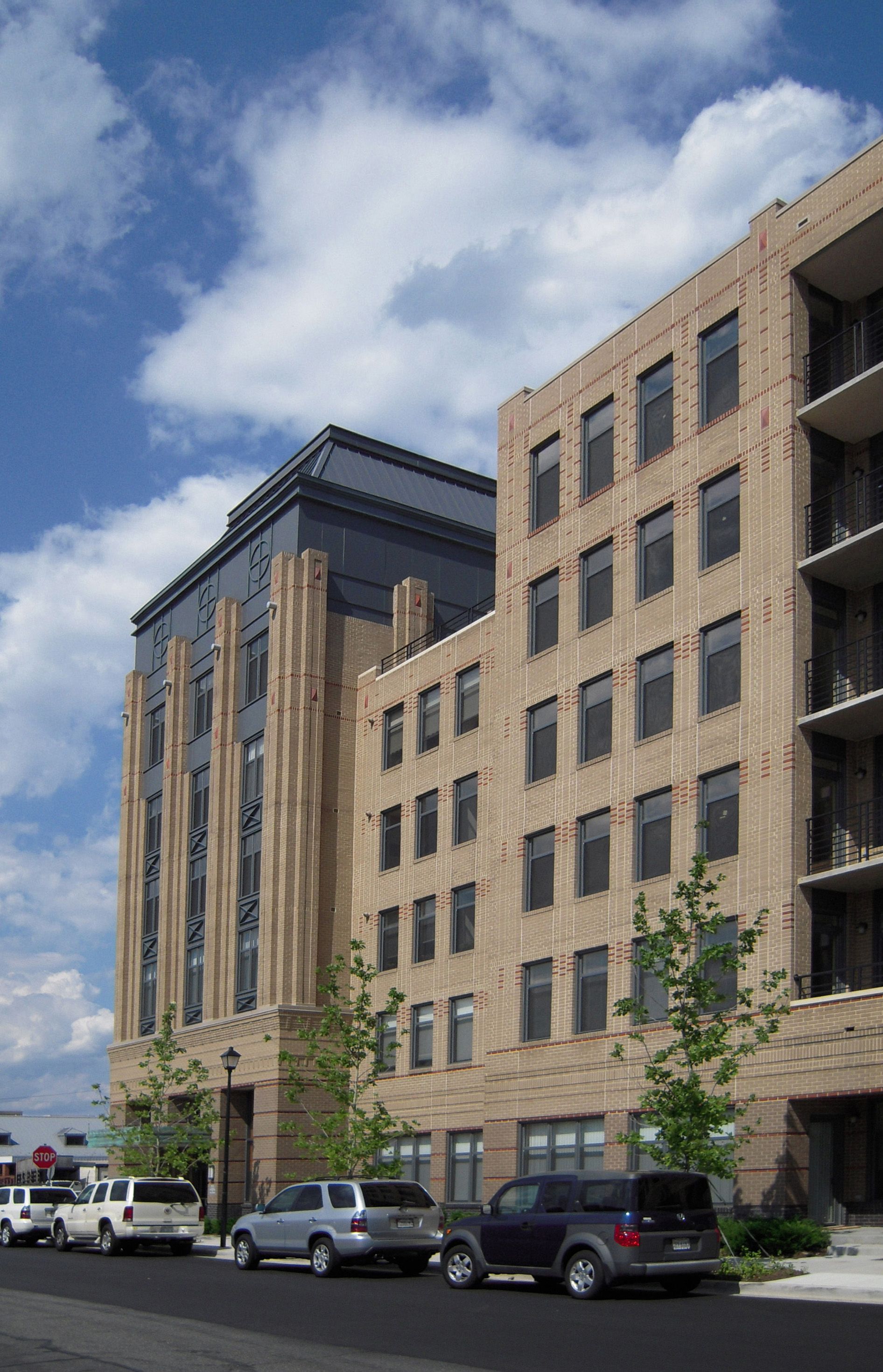 A large brick building with cars parked in front of it