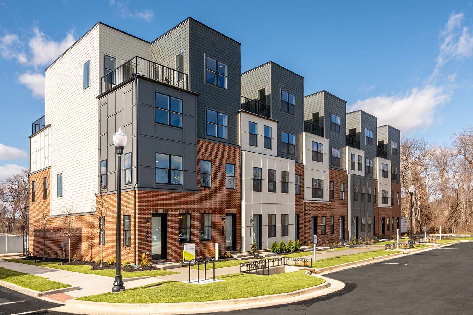 A large apartment building with a lot of windows on a sunny day.