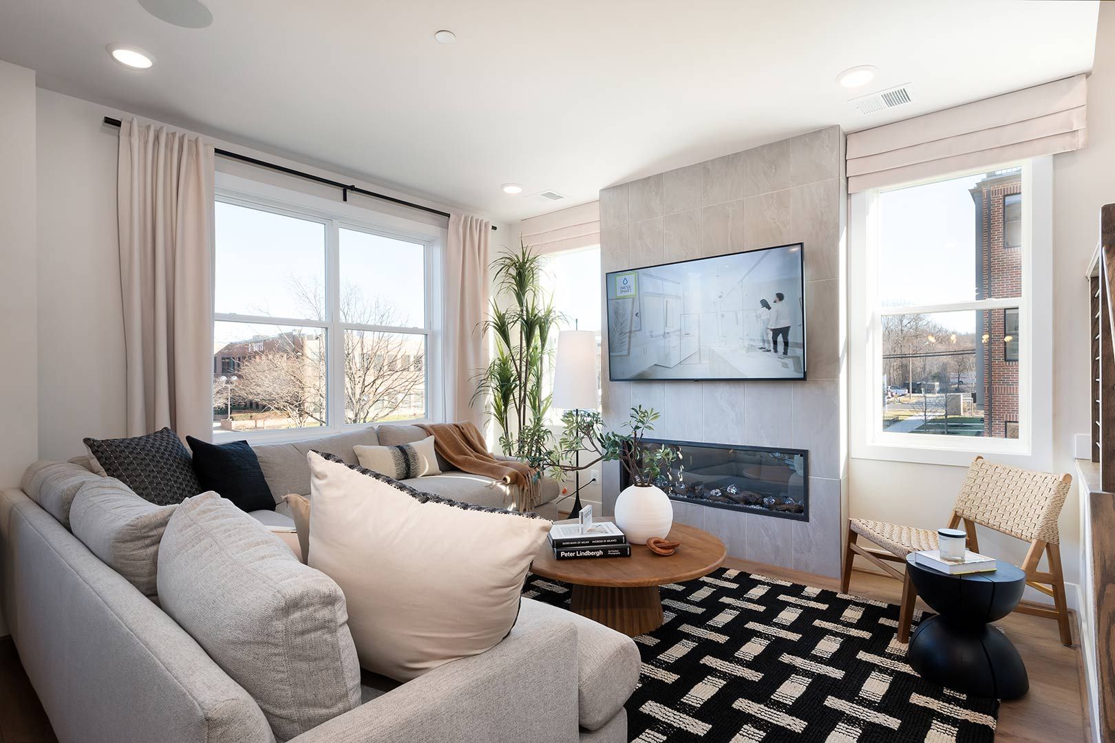 A living room with a couch , chairs , table and television.