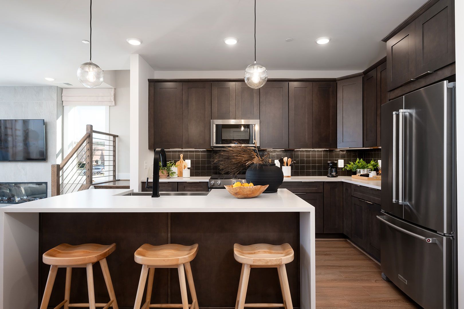 A kitchen with stainless steel appliances , wooden cabinets , and a large island.