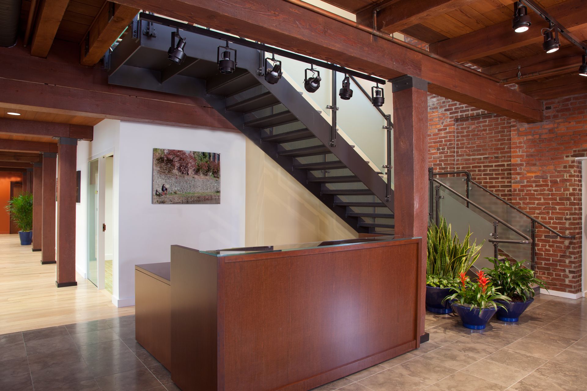 A lobby with a staircase and a reception desk