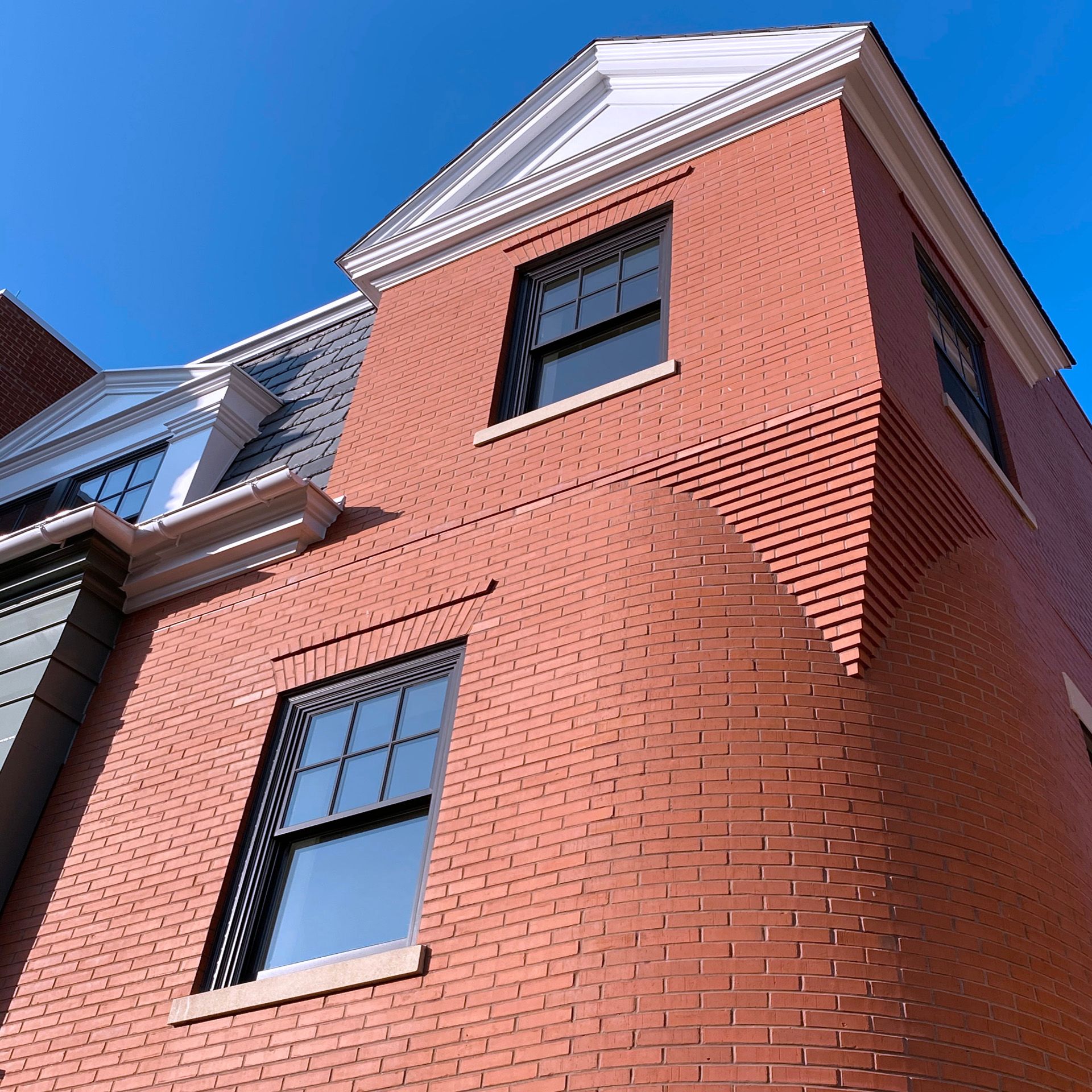 A red brick building with a blue sky in the background