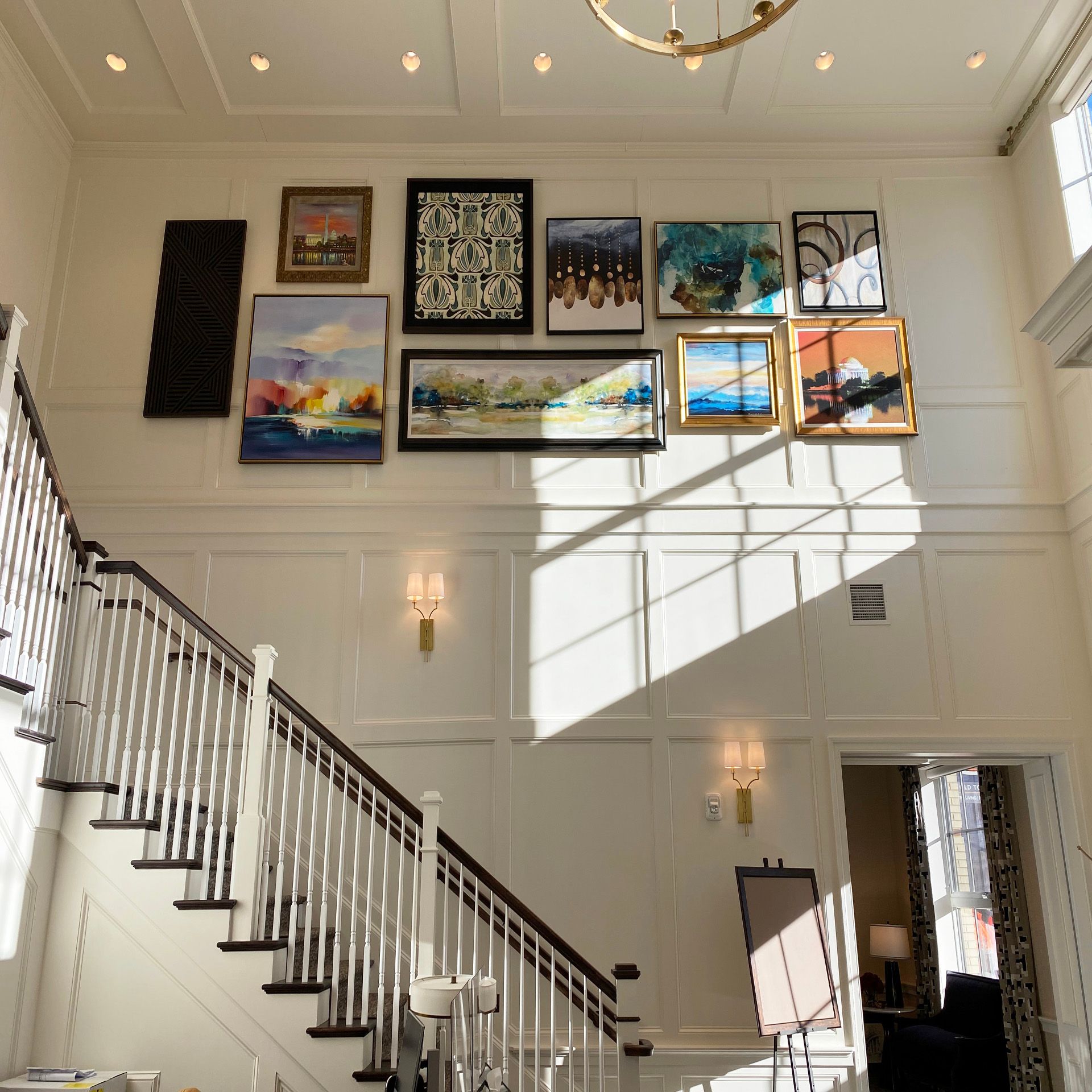A staircase with paintings on the wall above it