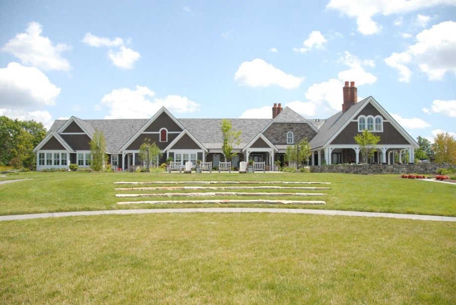 A large house with a large lawn in front of it