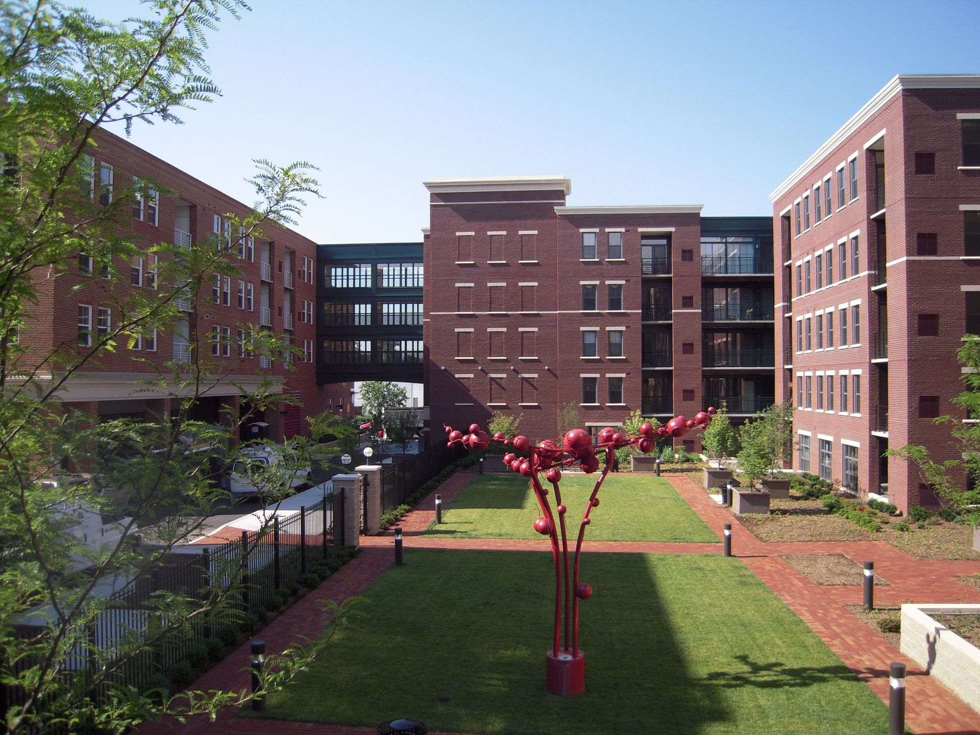 A large brick building with a large lawn in front of it