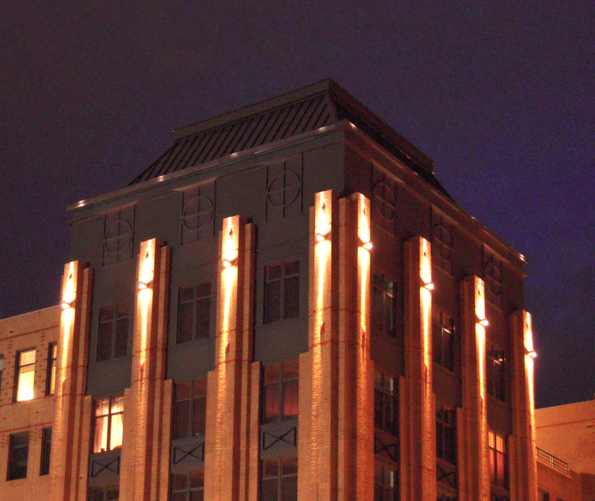 A building with a lot of windows is lit up at night