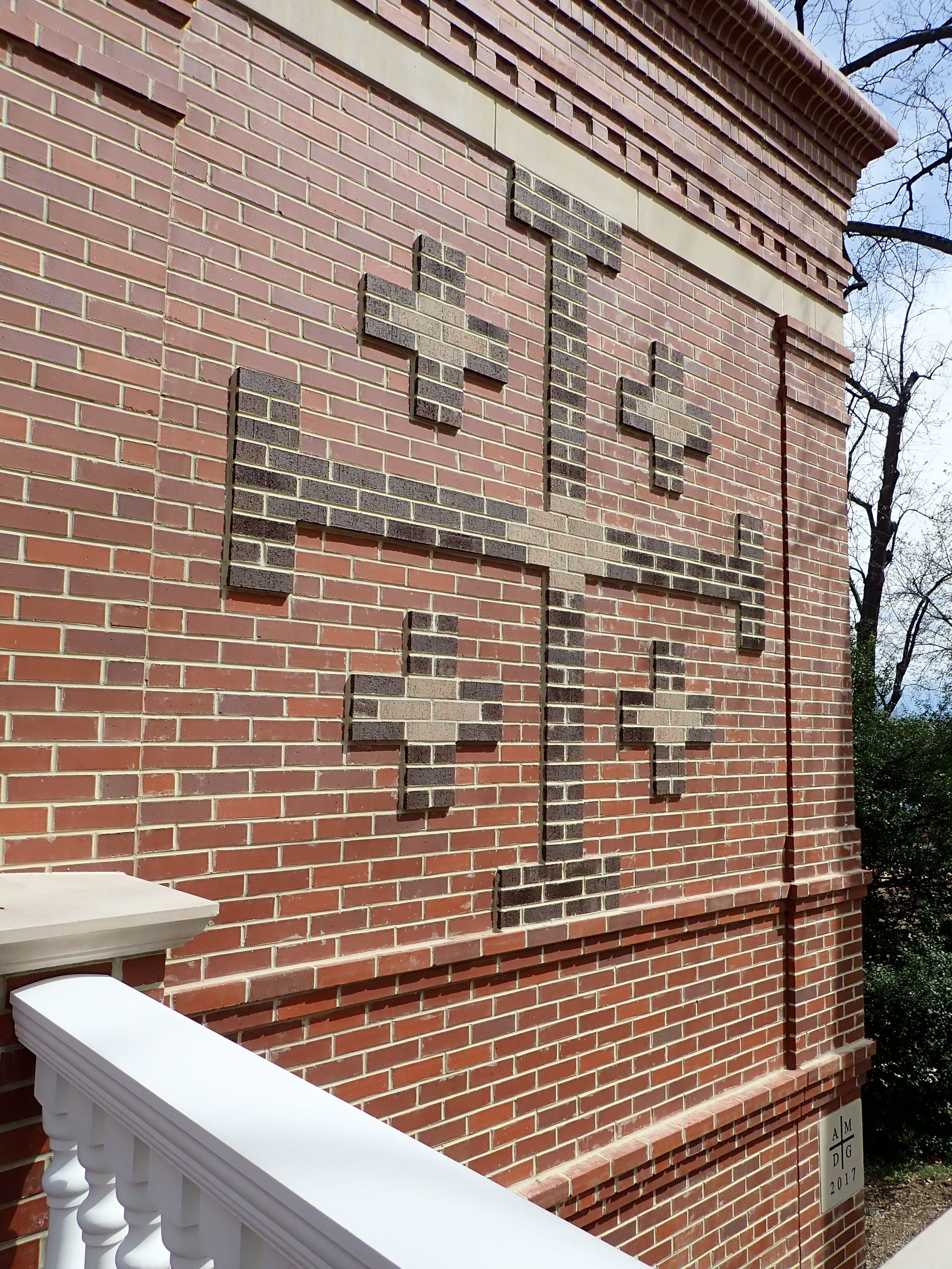 A brick wall with a cross on it
