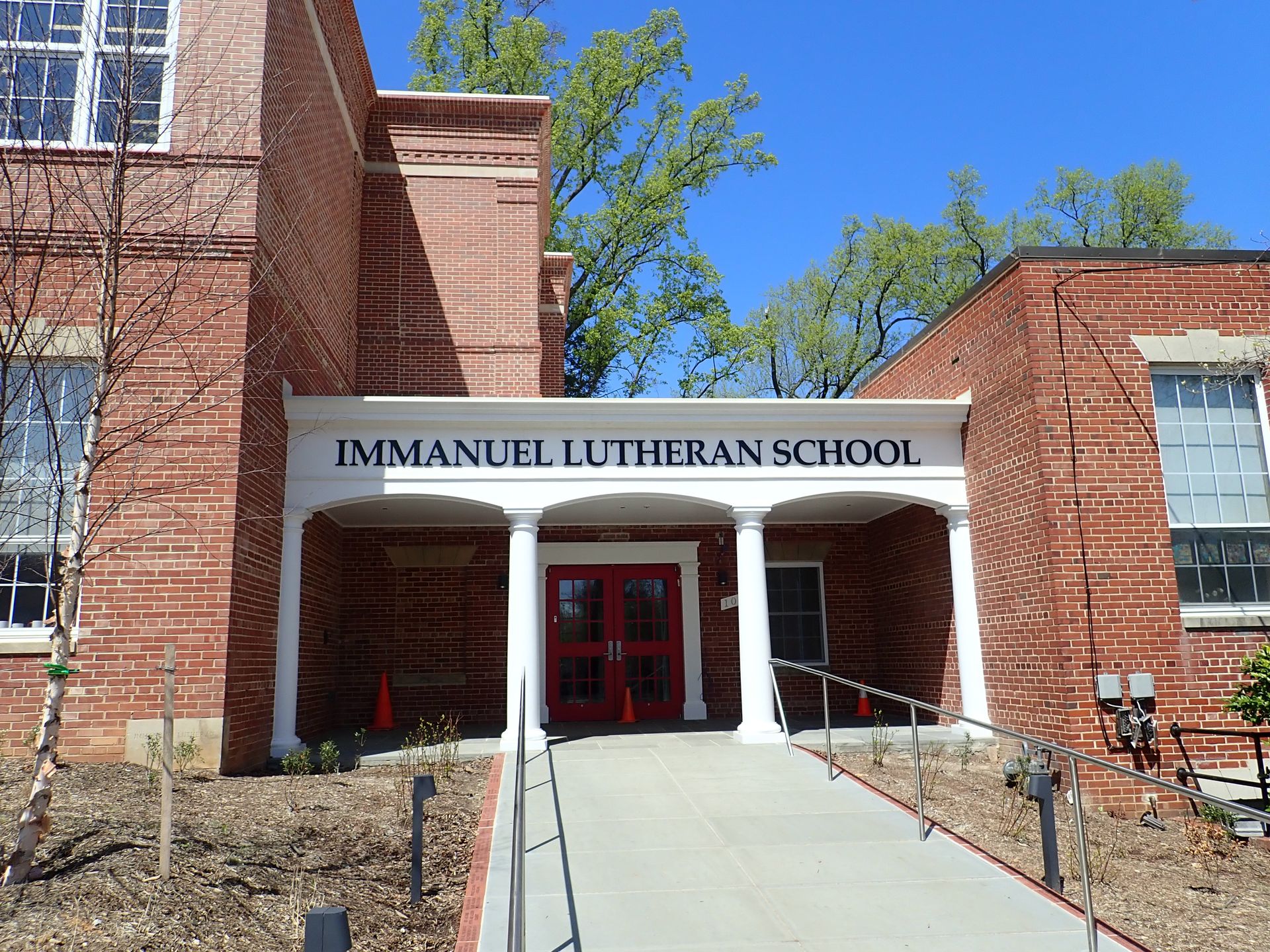 A brick building with a sign that says emmanuel lutheran school