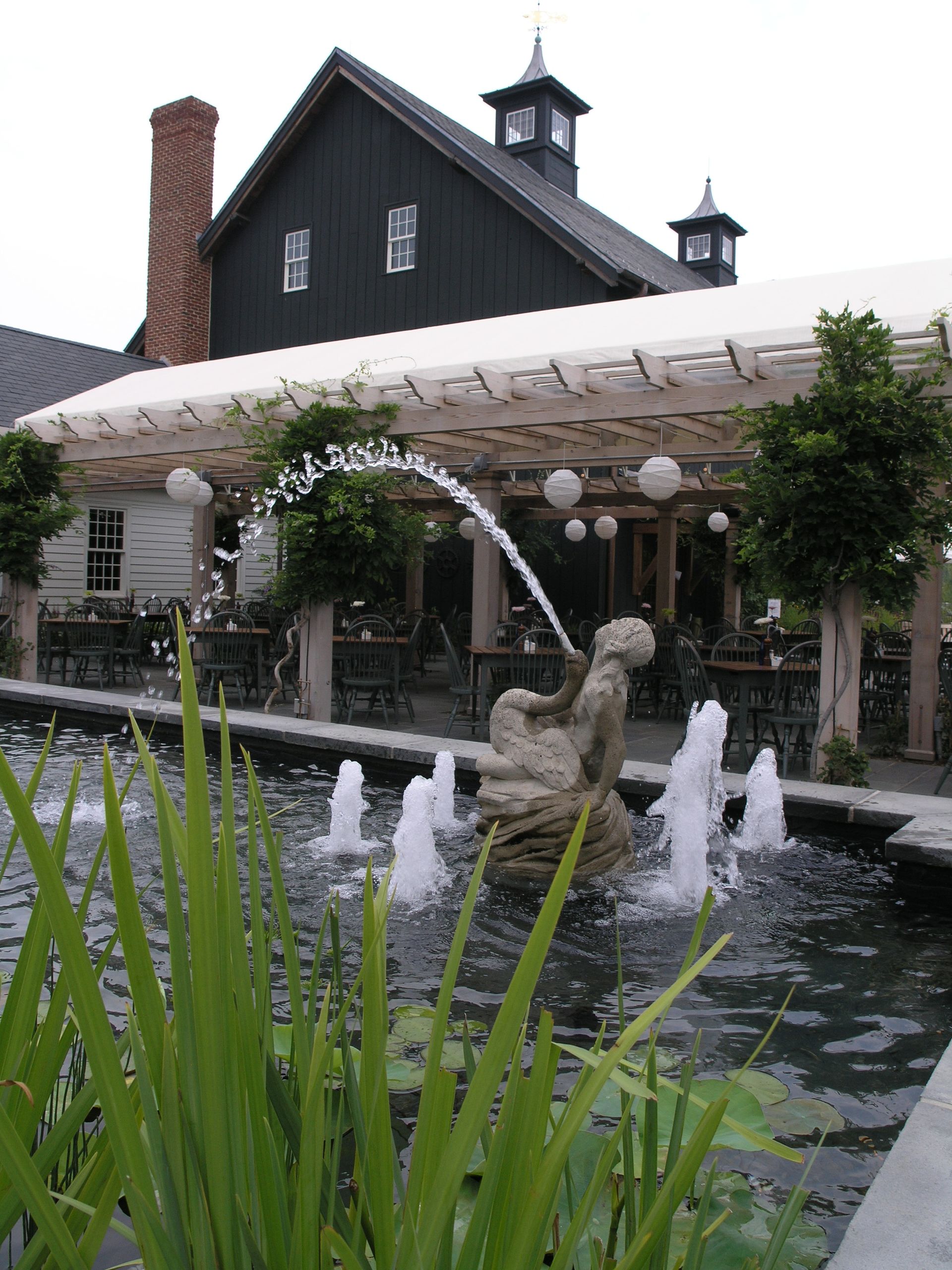 A fountain with a statue in front of a building