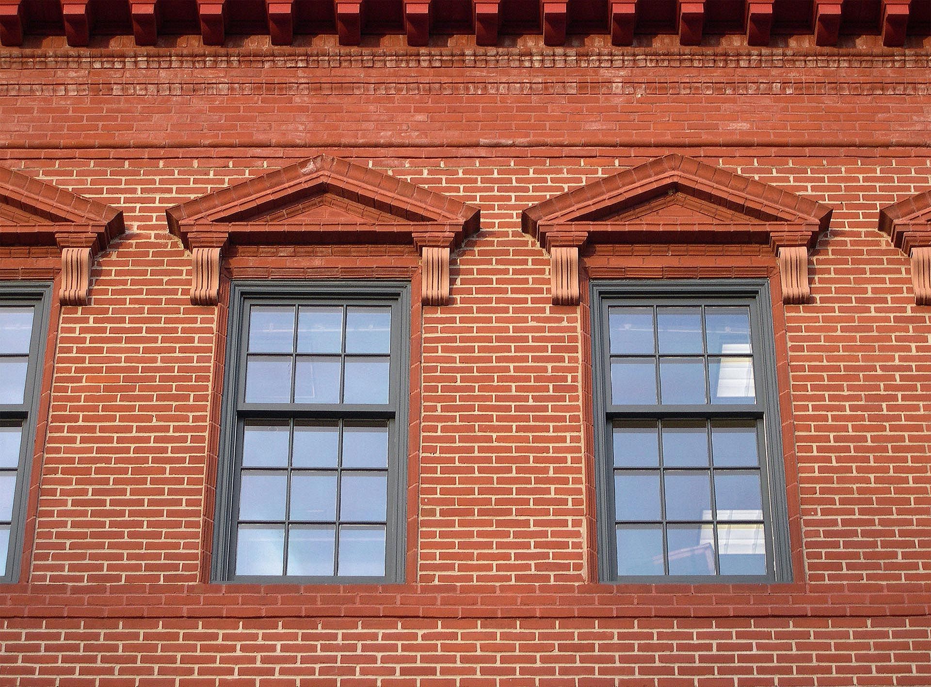 A brick building with a lot of windows on it