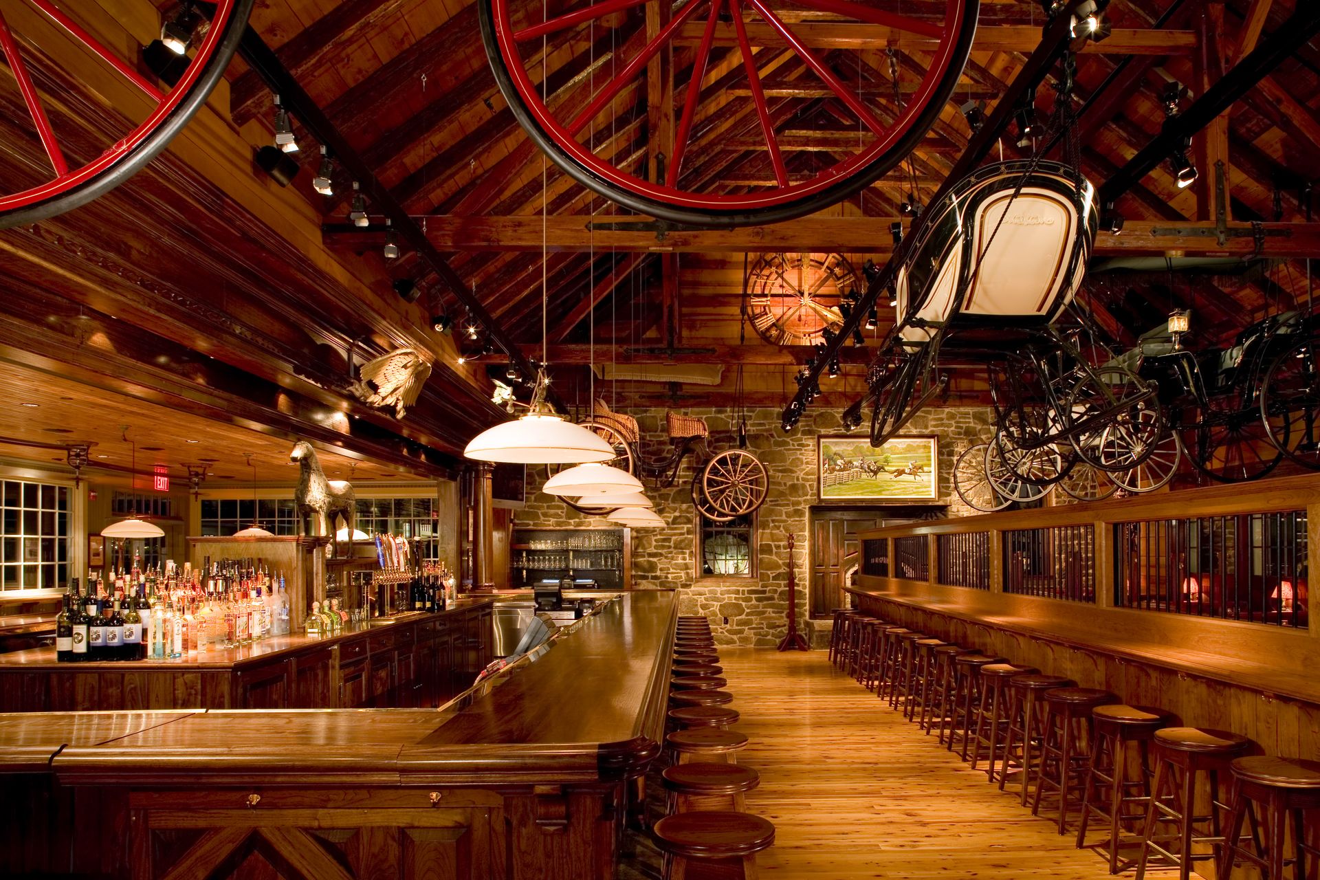 A restaurant with a long wooden bar and stools