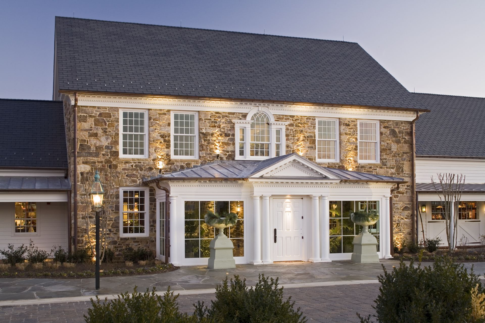 A large stone building with a white door and windows