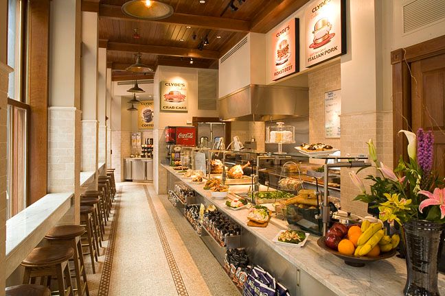 A long hallway in a restaurant with a coca cola sign on the wall