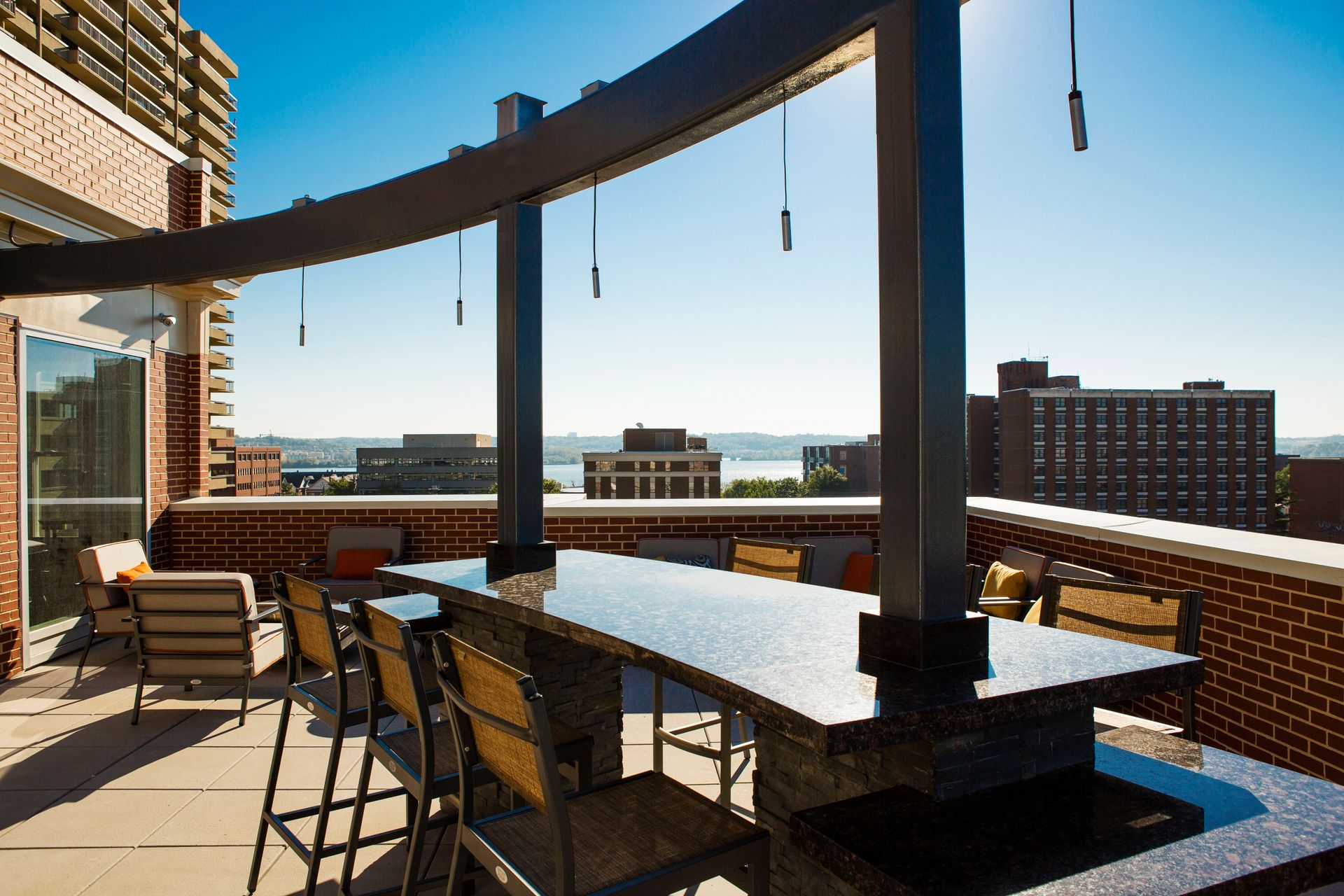 A patio with a table and chairs and a view of a city