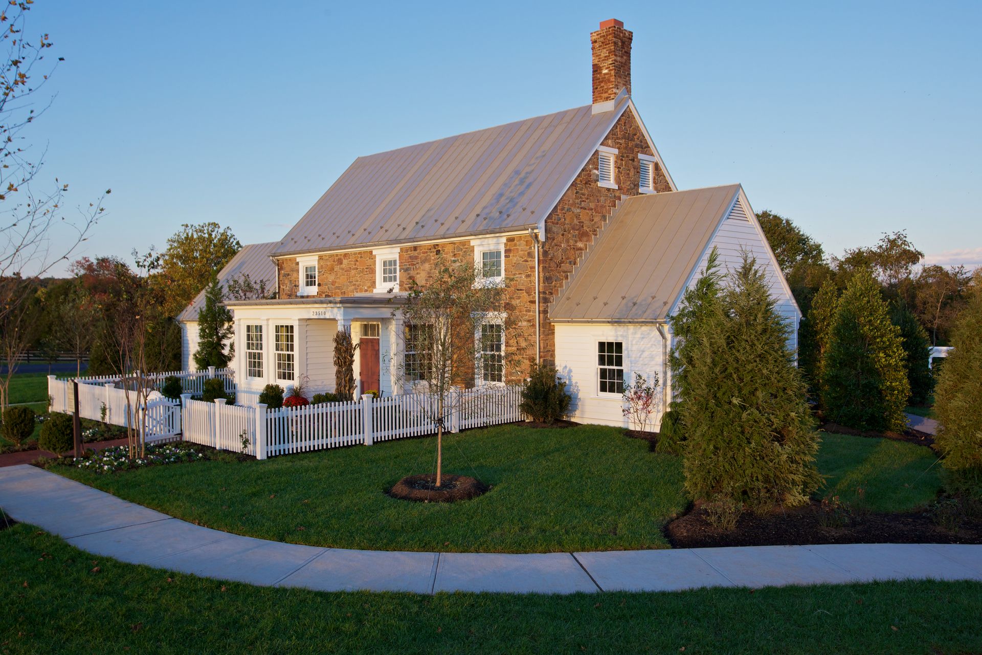 A large house with a white picket fence in front of it
