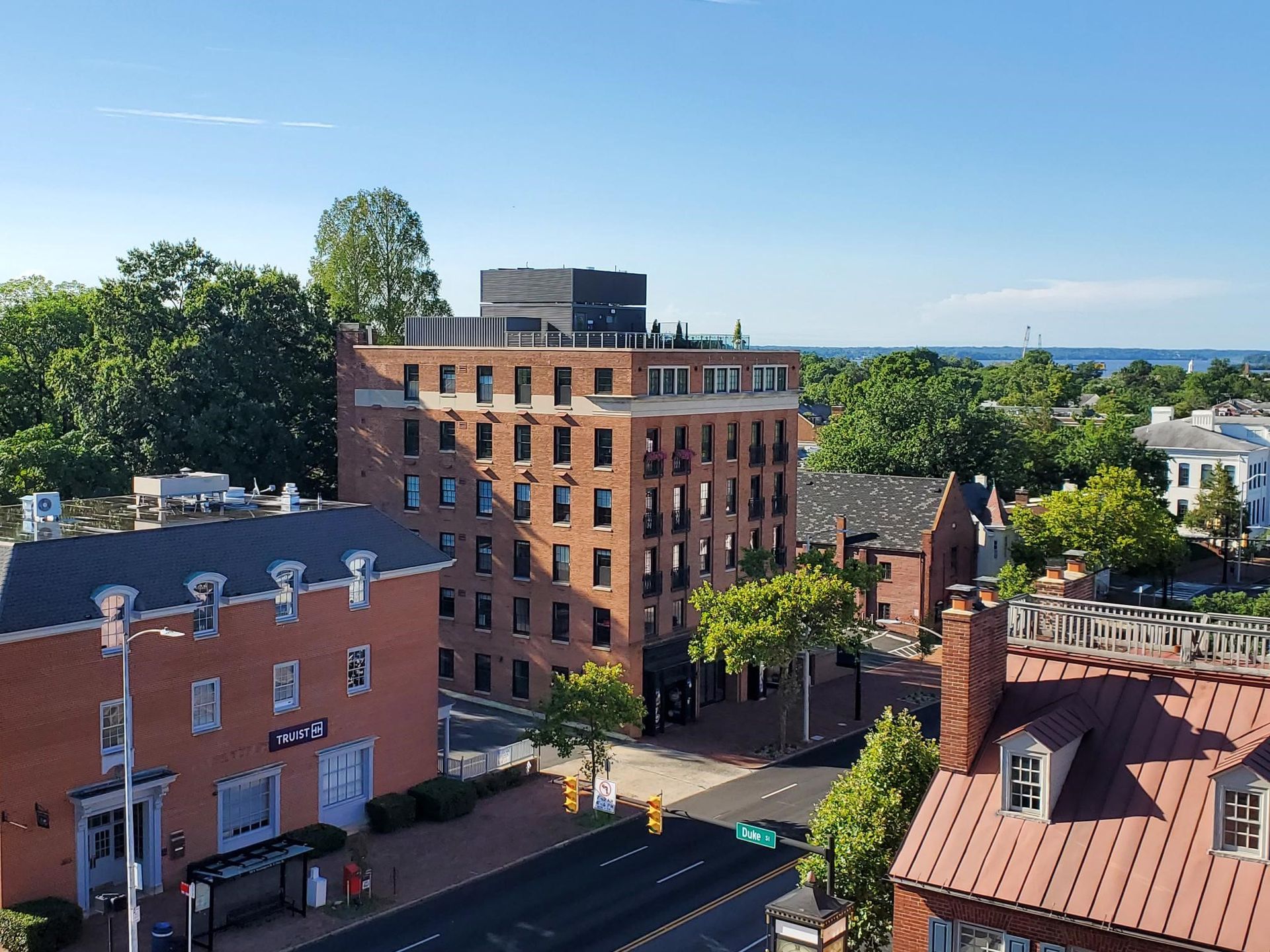 An aerial view of a city with a large brick building in the middle