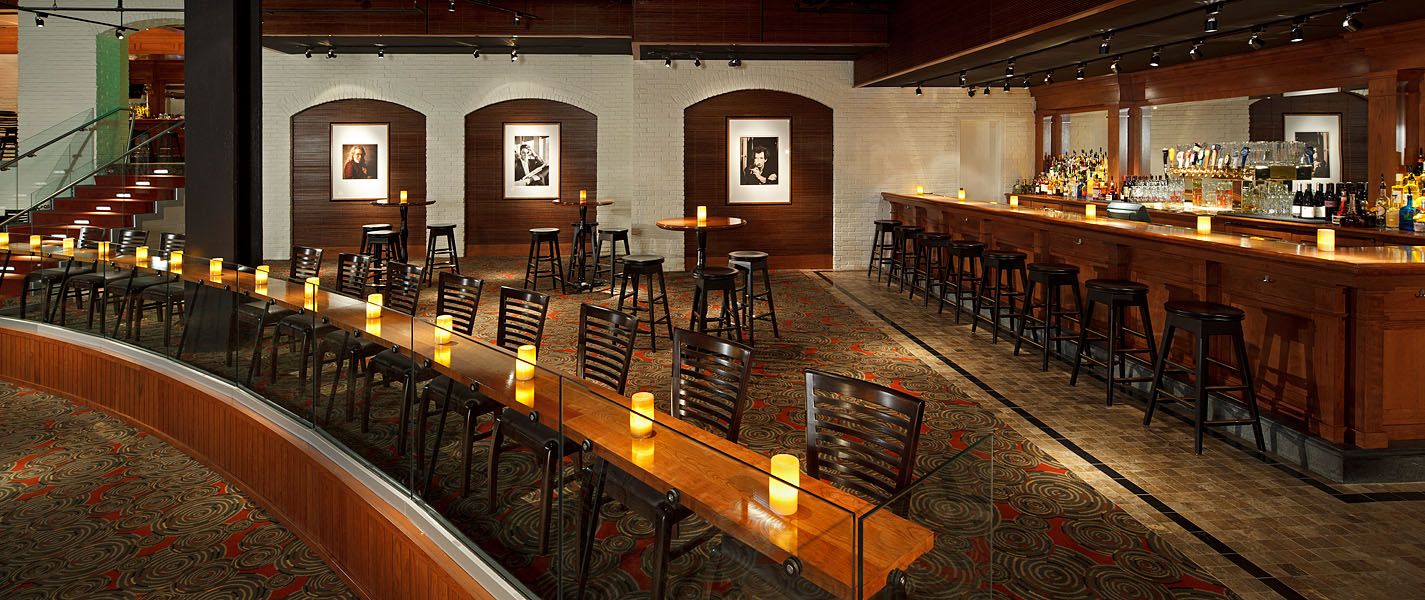A restaurant with tables and chairs and a bar