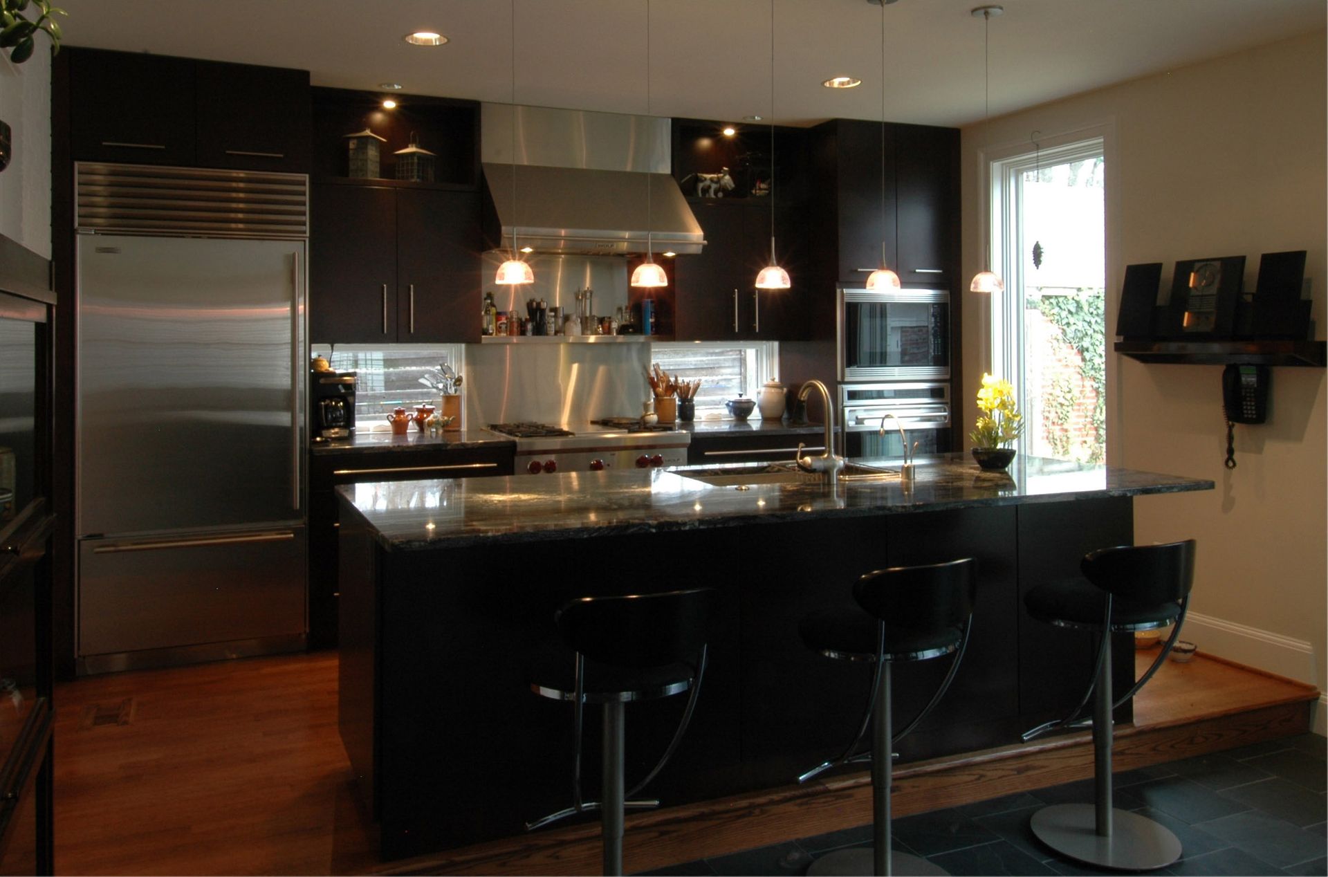 A kitchen with a large island and stools