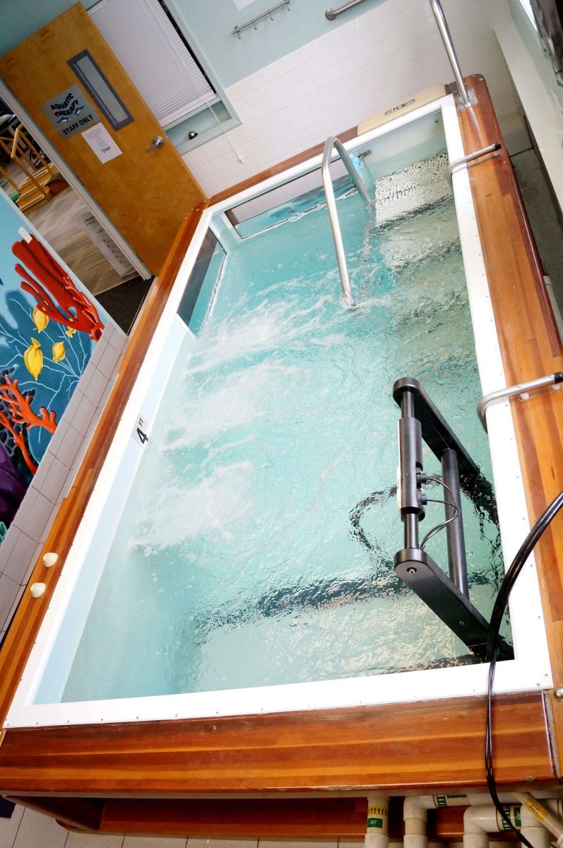 A large swimming pool with a ladder in it
