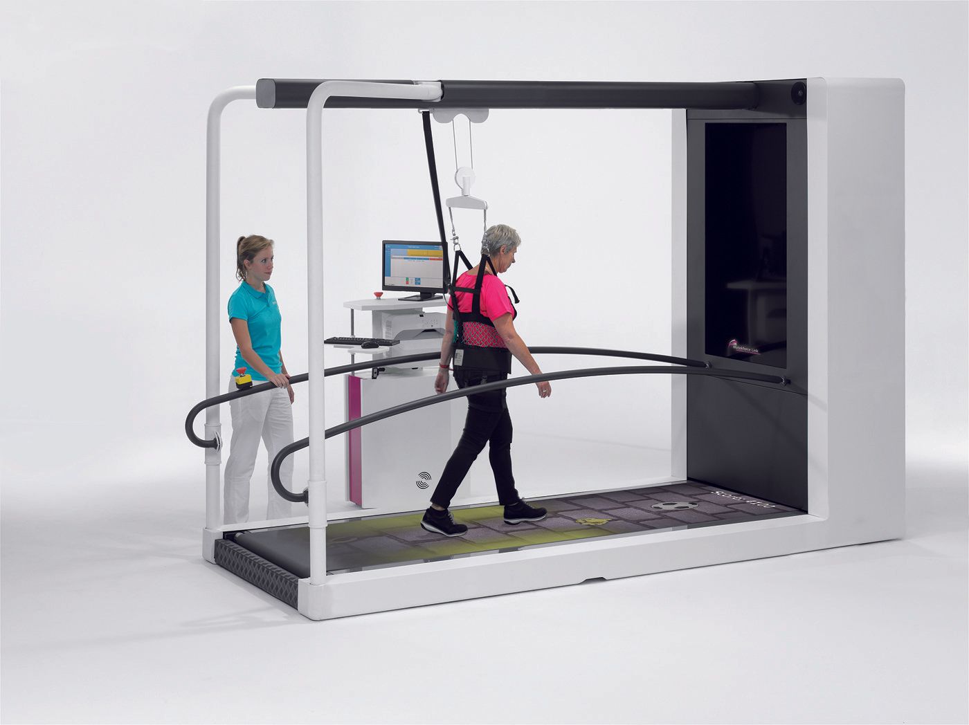 A woman is walking on a treadmill while another woman watches.