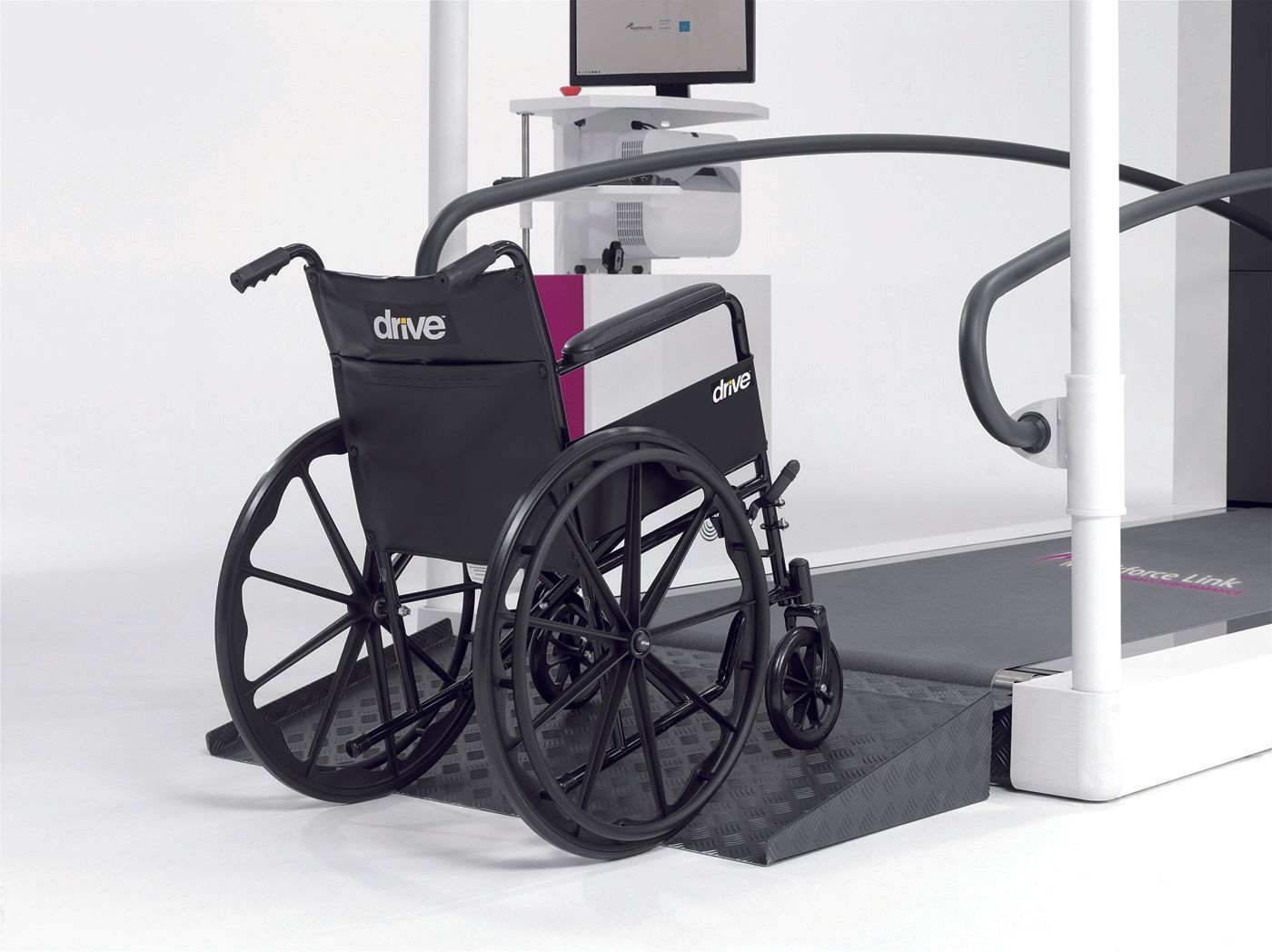 A wheelchair is sitting on top of a treadmill.