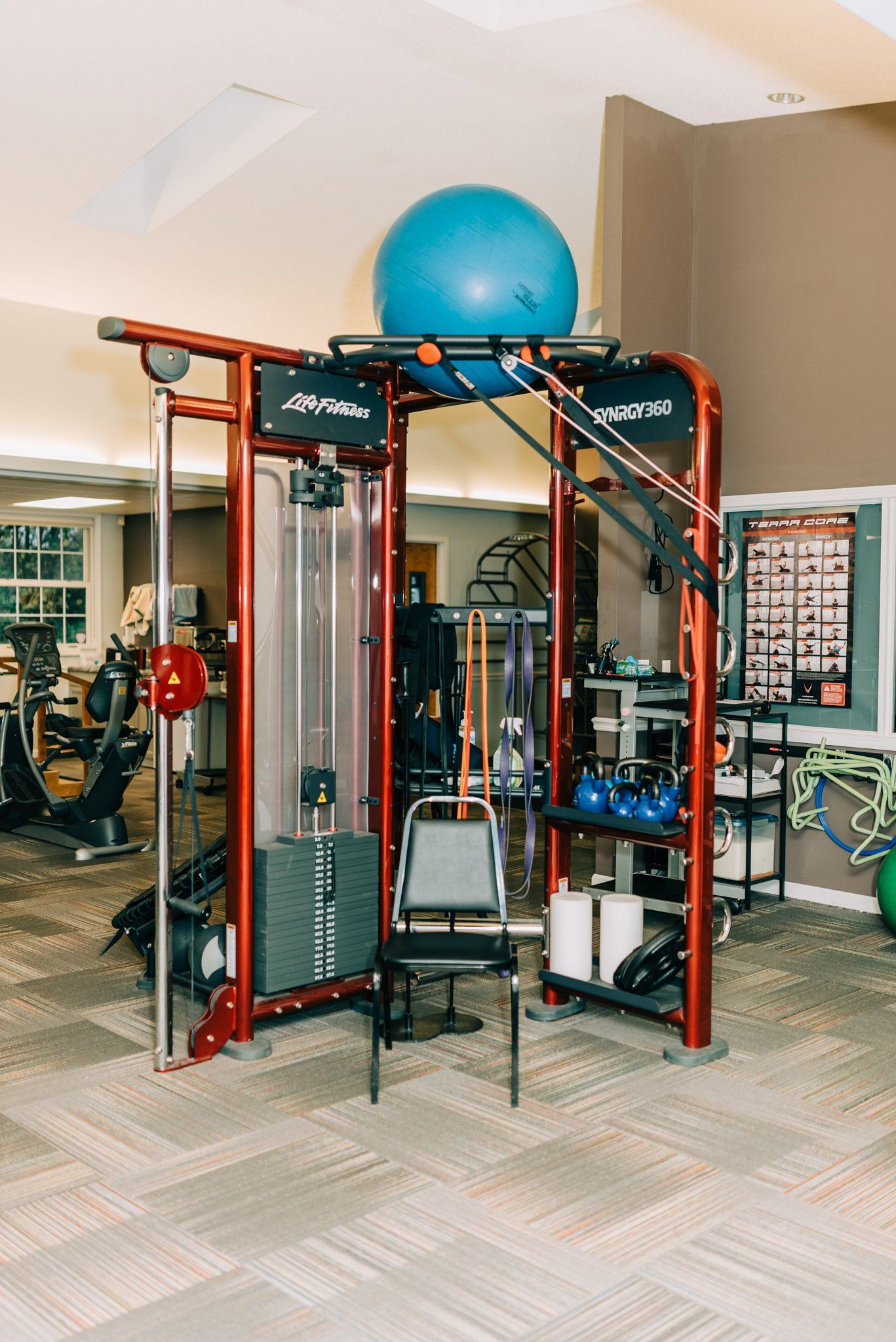 A gym with a blue ball on top of a machine