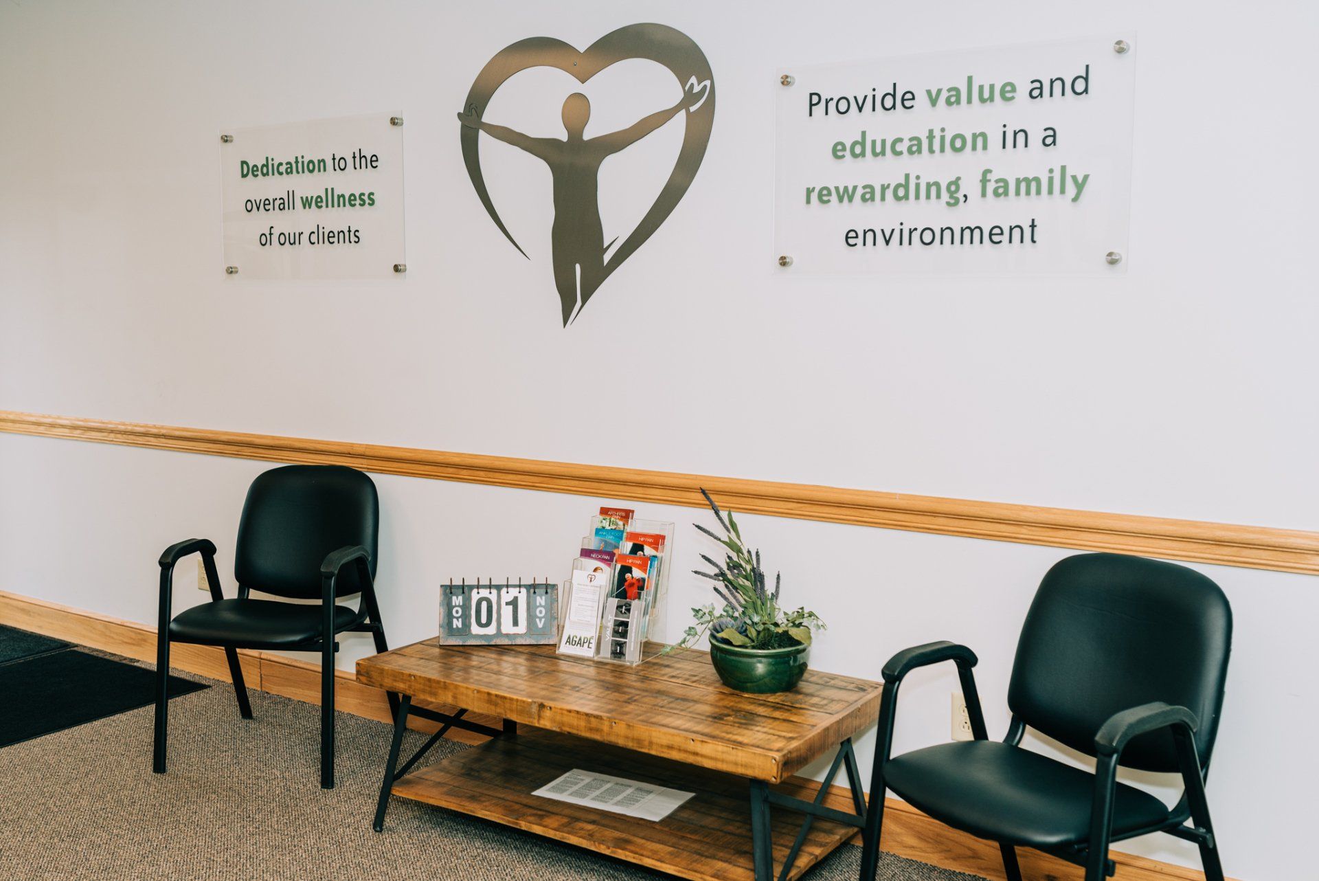 There is a sign on the wall that says provide value and education in a rewarding family environment.